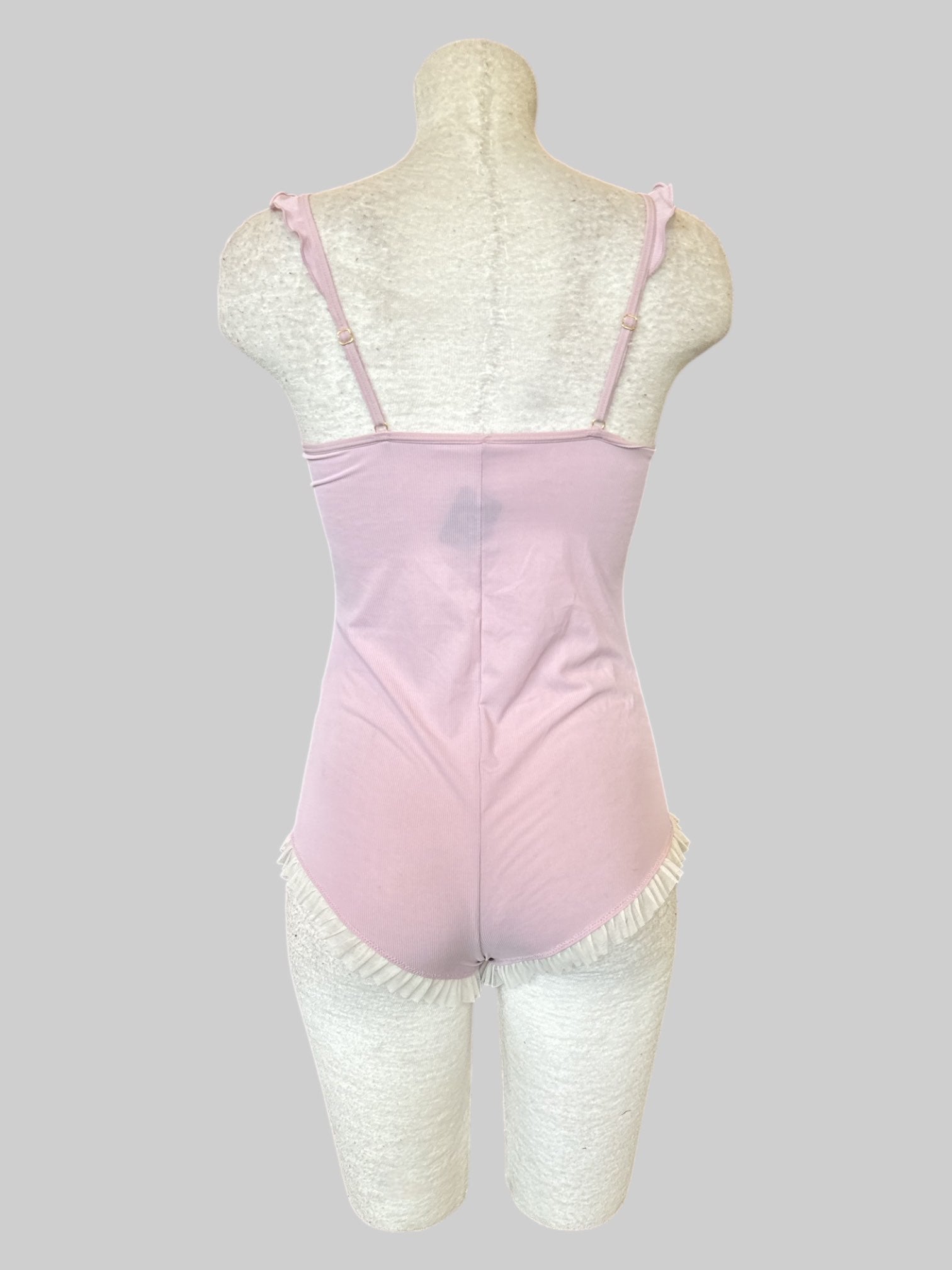 S Stretchy pink romper with ruffle details and bows