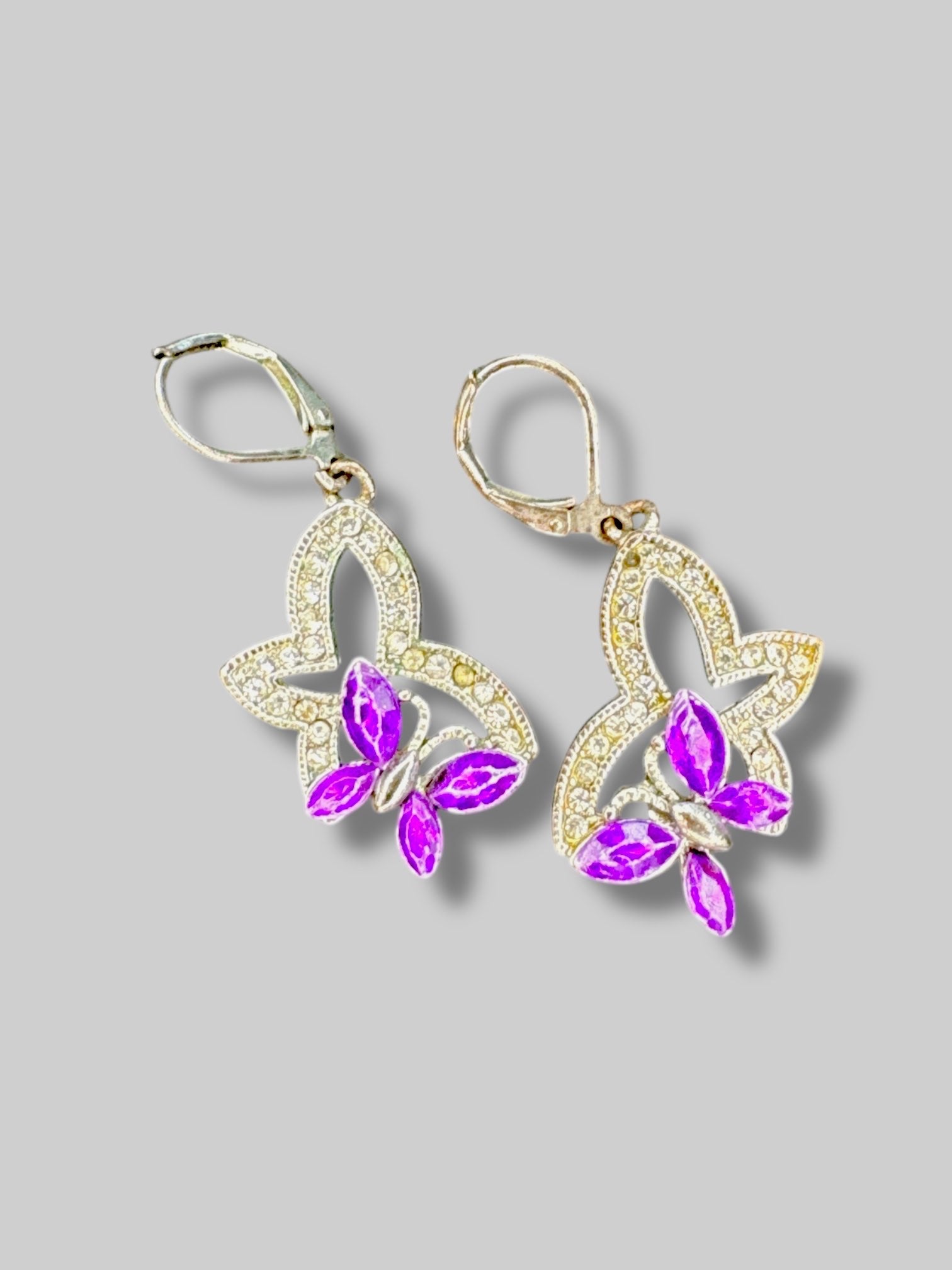 Silvertone butterfly earrings with purple gems