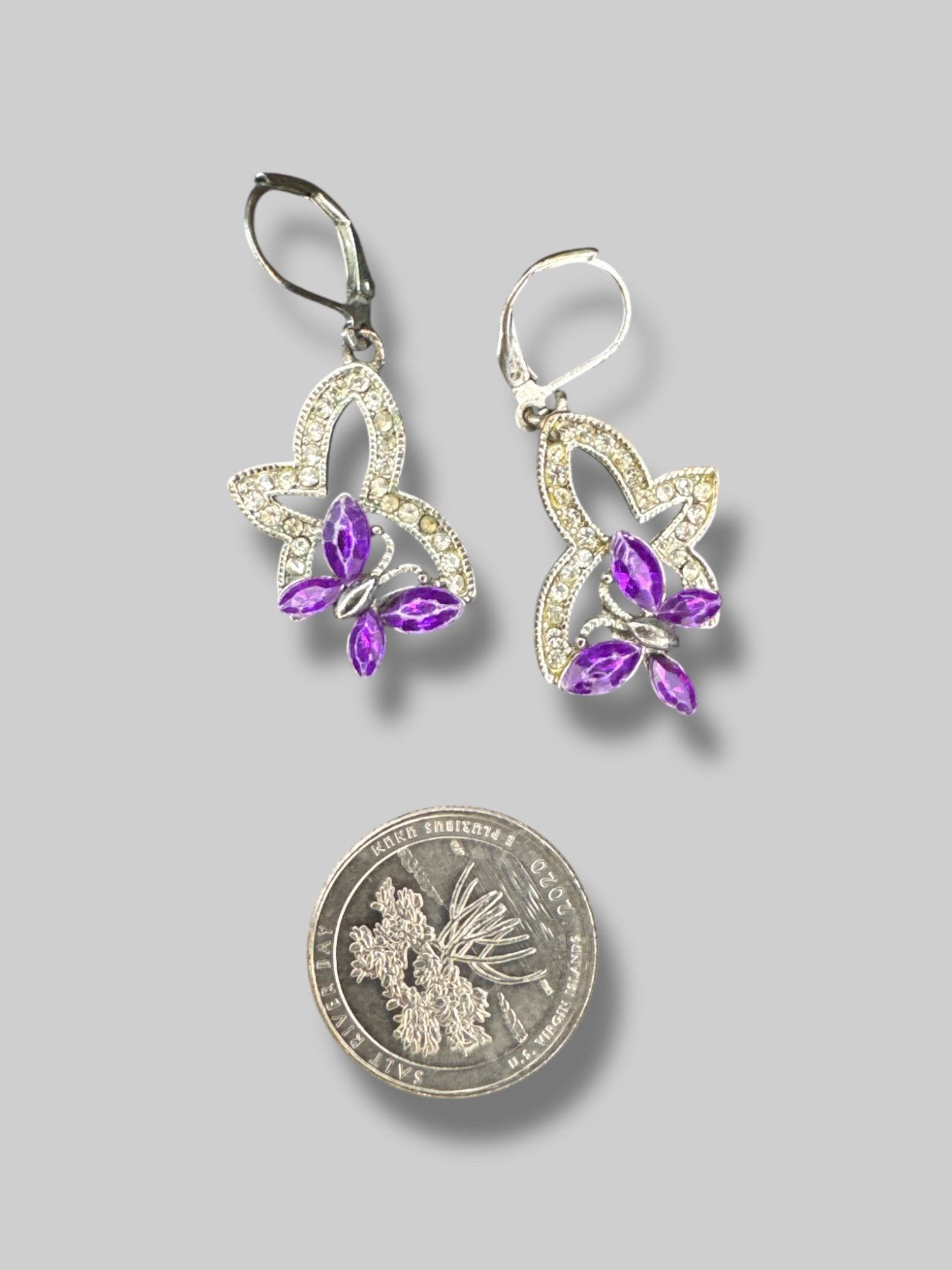 Silvertone butterfly earrings with purple gems