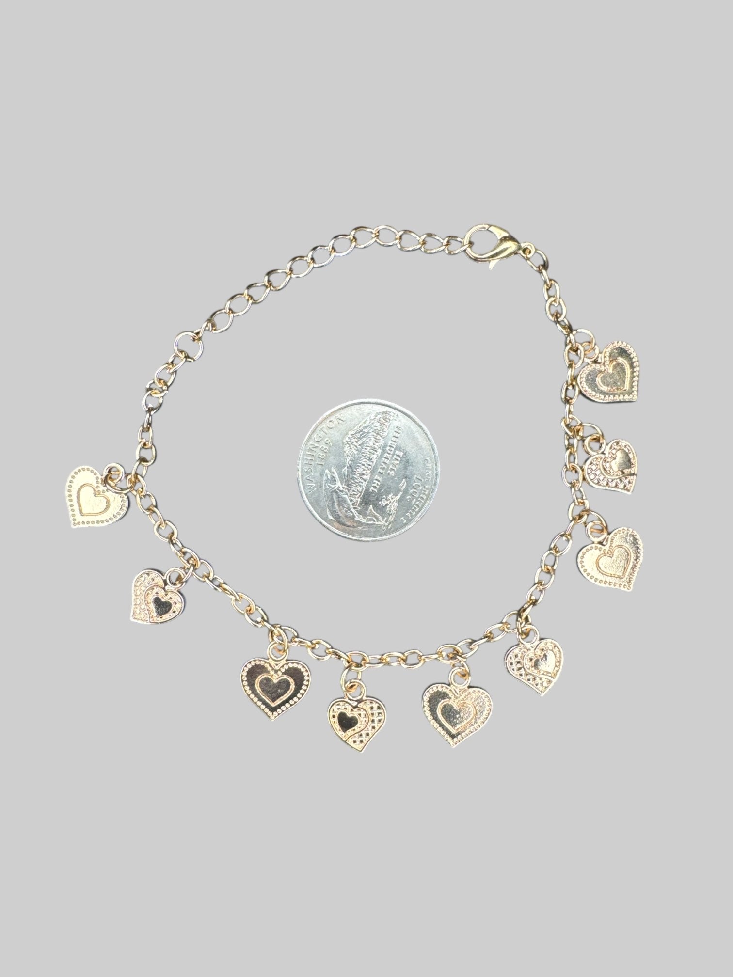 Gold tone heart charm bracelet