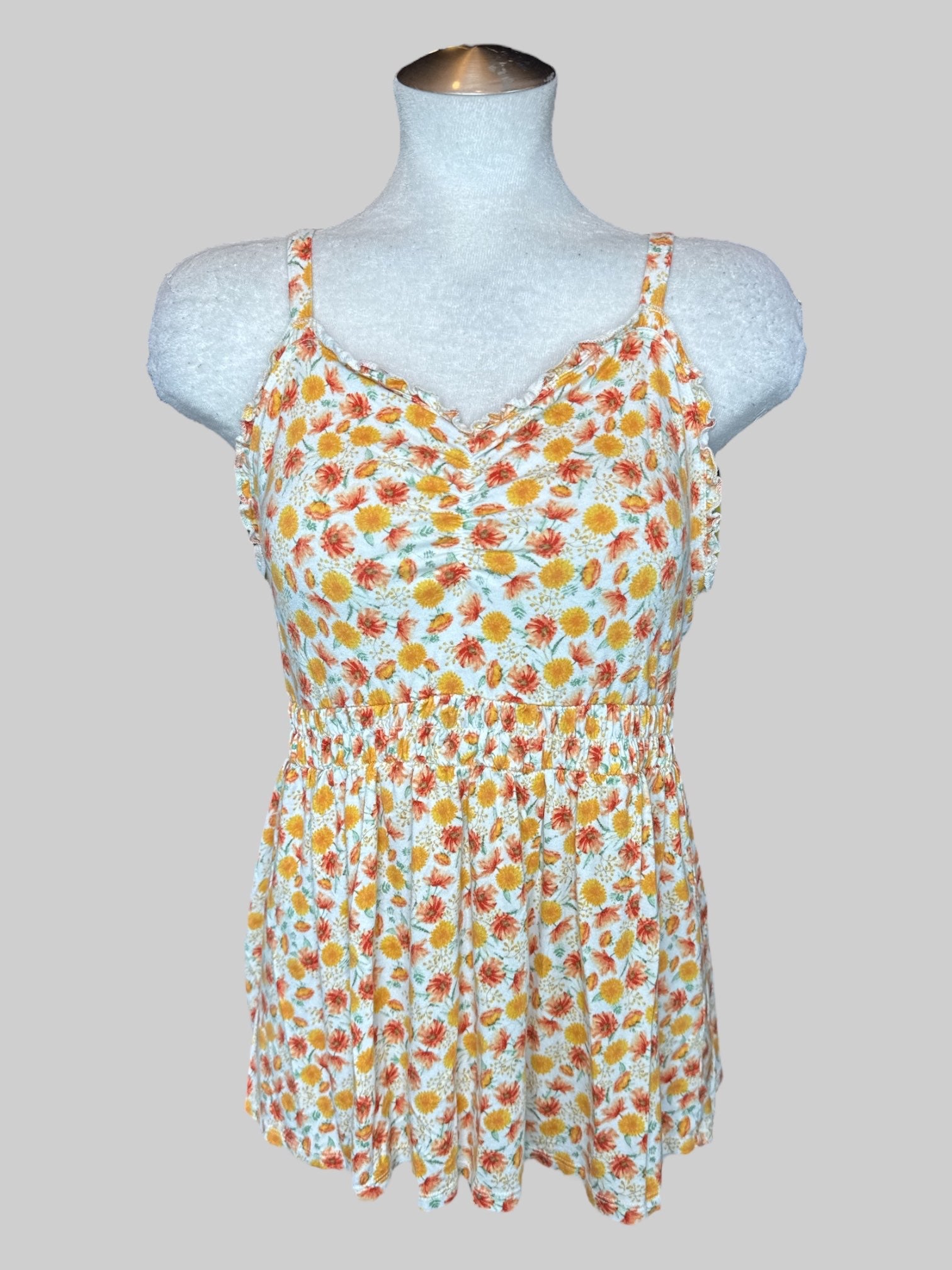 L White flowy tank top with orange and yellow florals and shirred  waist