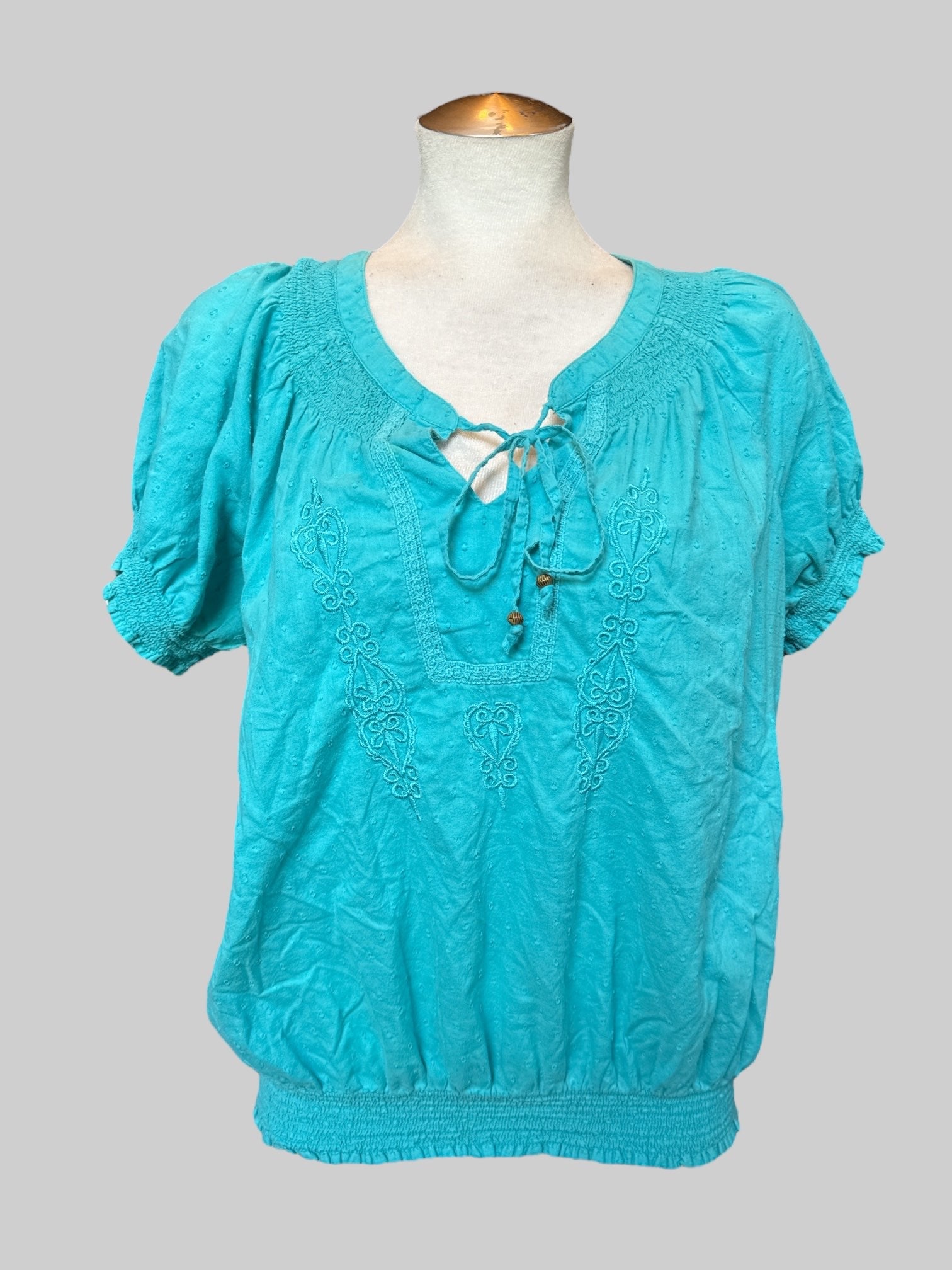 L blue top with textured polka dots, embroidery, and balloon sleeves and waist