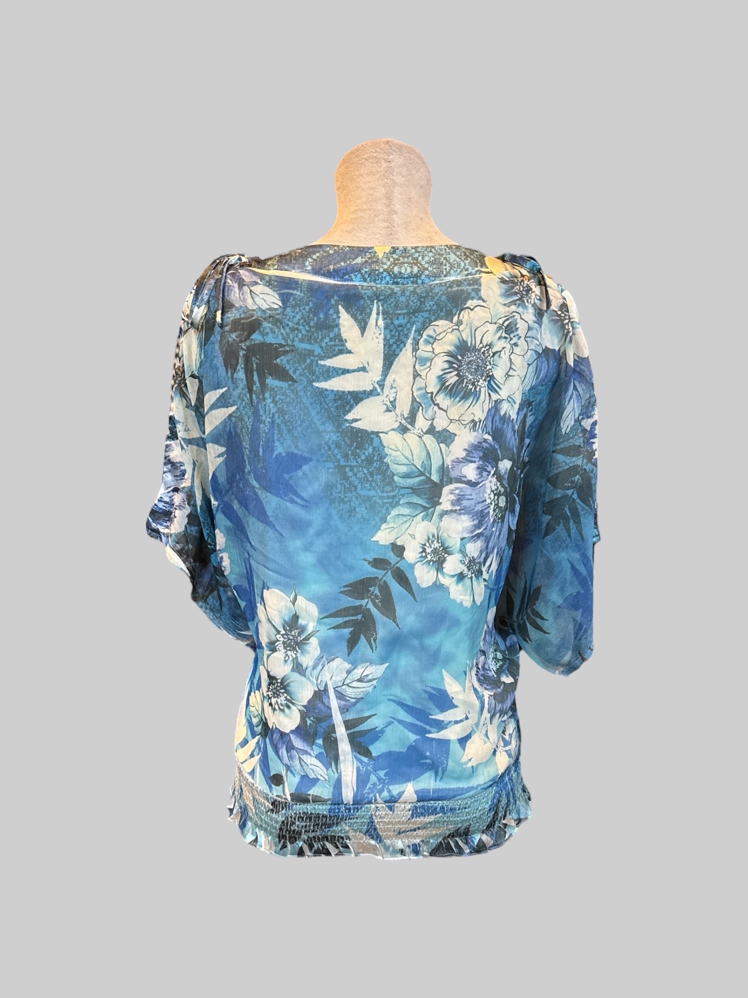 XL blue and white floral top with sheer layer, cold shoulders with ties, and shirred waist