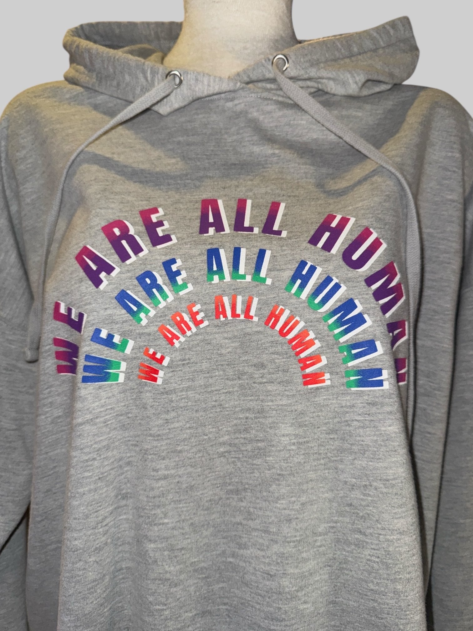 0X Heather Gray hoodie with “we are all human” graphic