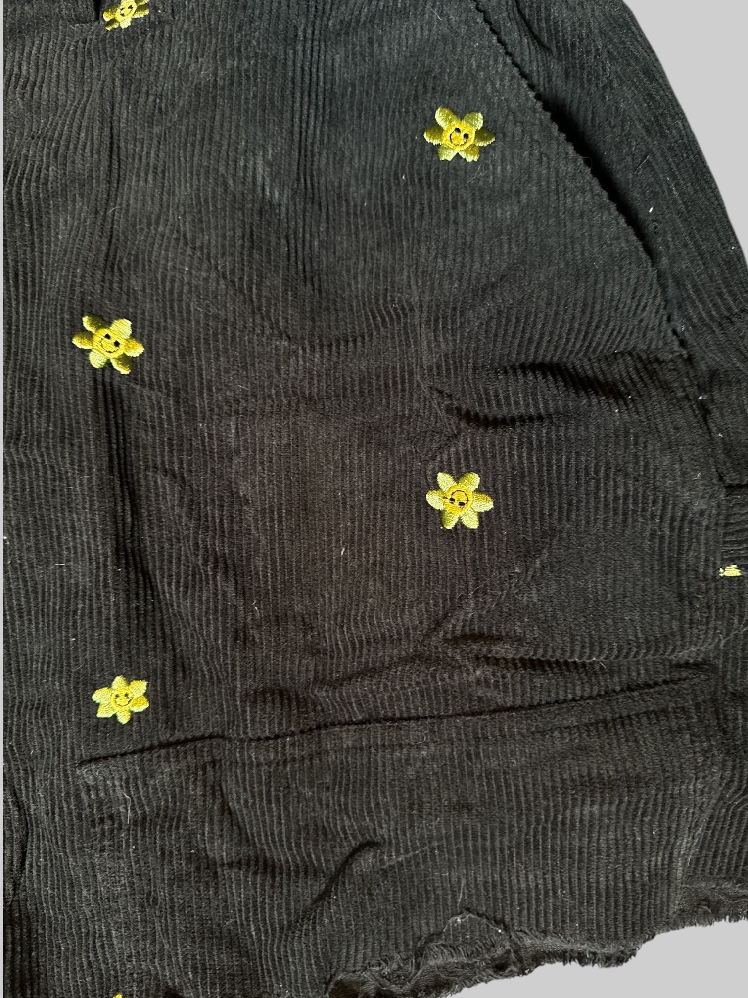 1X Black corduroy cut off shorts with smiley flowers