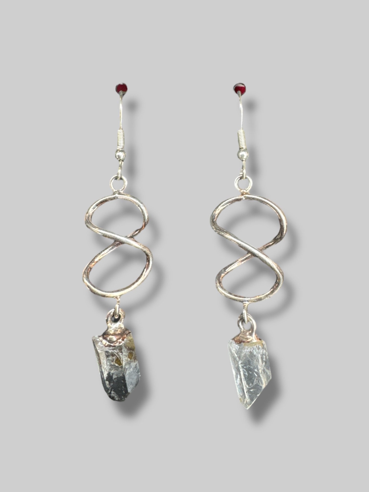 Silver tone twist dangle earrings with crystals