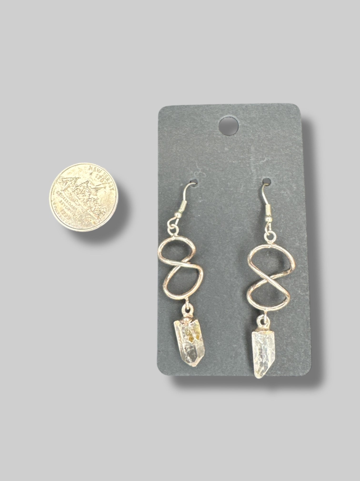 Silver tone twist dangle earrings with crystals