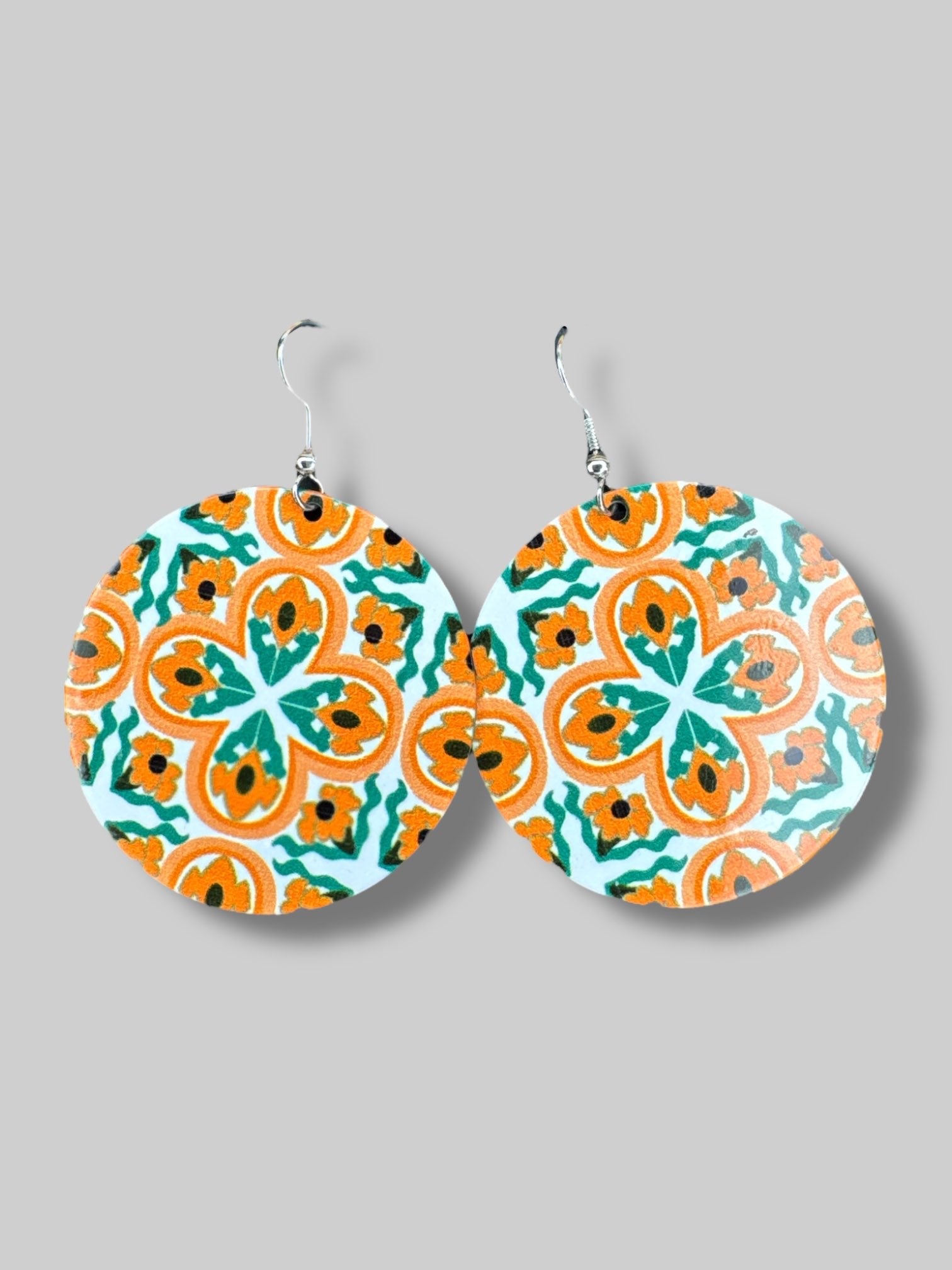 Orange and green dangly metal earrings