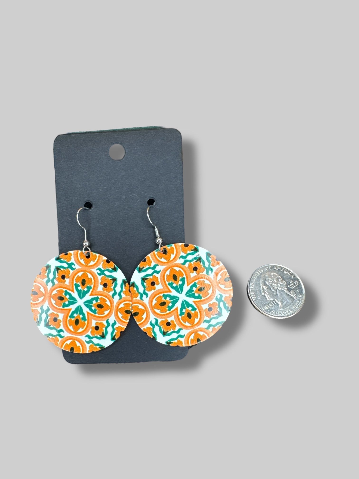 Orange and green dangly metal earrings