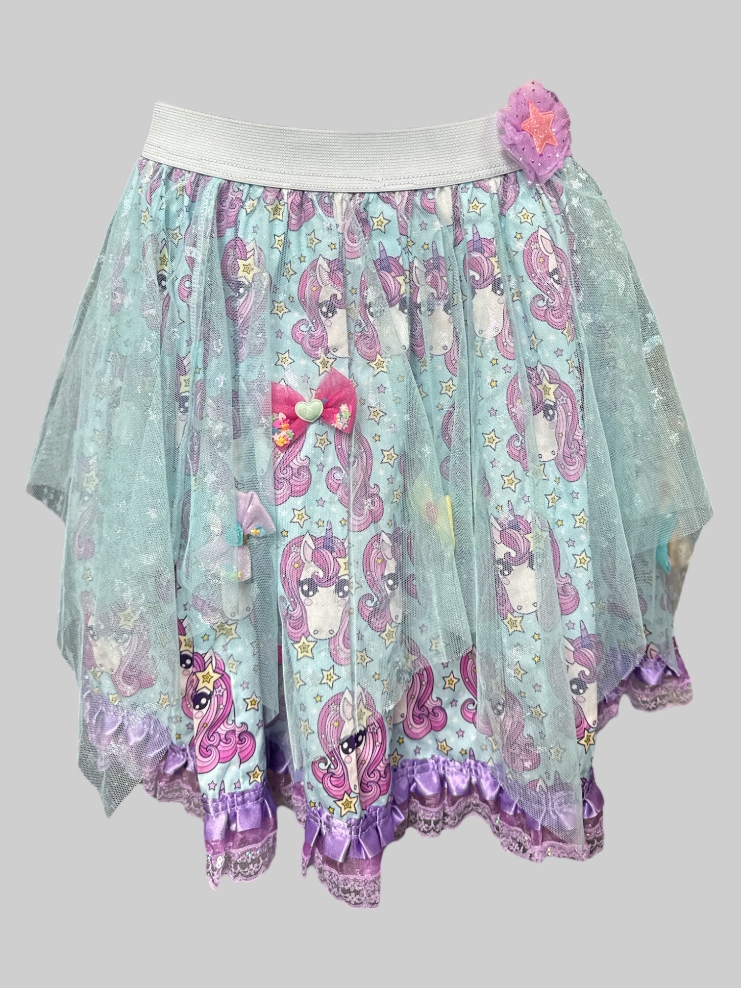 L Blue skirt with pink unicorns, yellow stars, little bows with hearts, blue tulle overlay with glittery stars and moons, and elastic waistband
