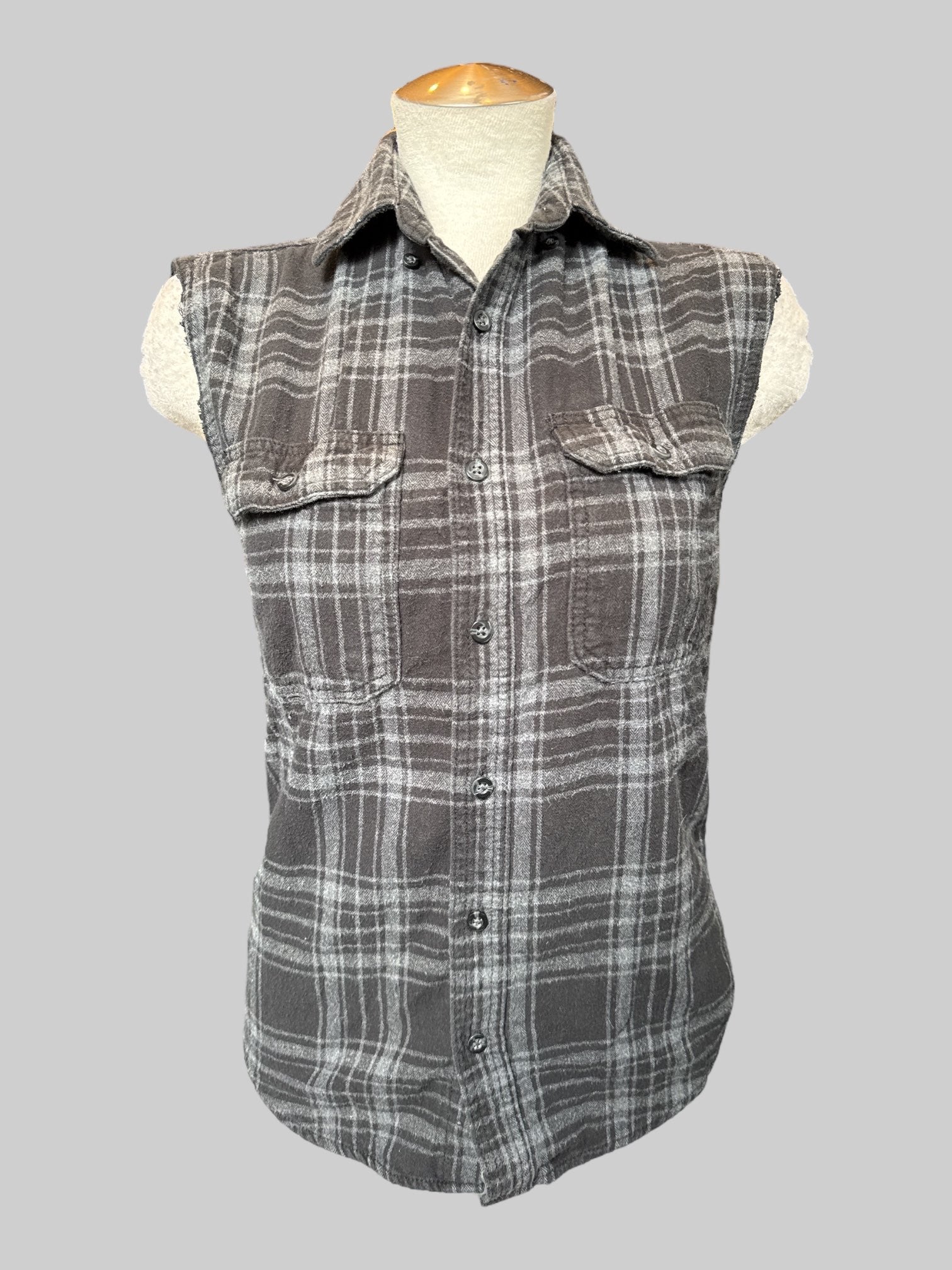 S Black flannel with cut off sleeves and hand cut Spider-Man patch on back with safety pins