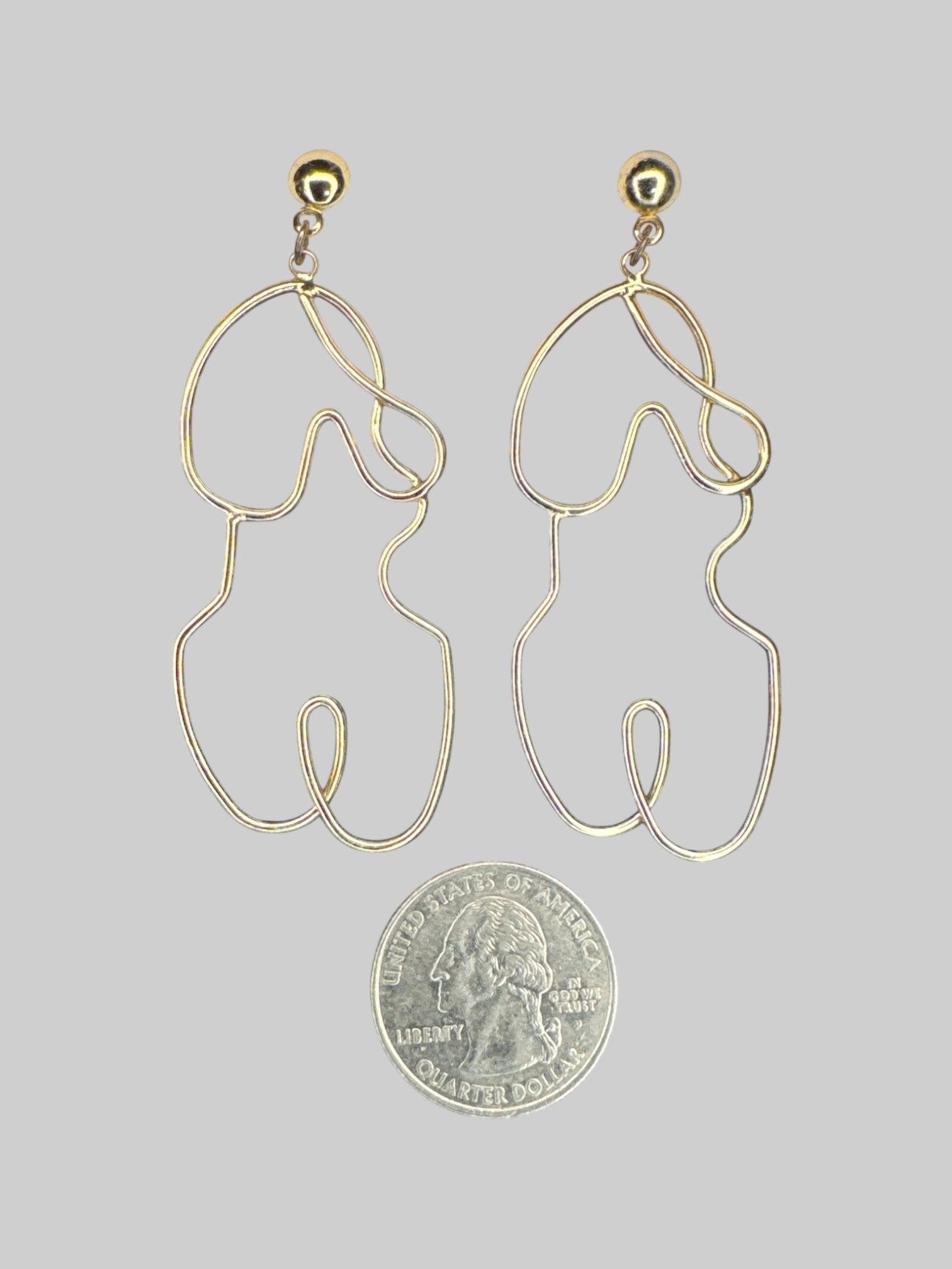 Gold tone wire wrap earrings in shape of body