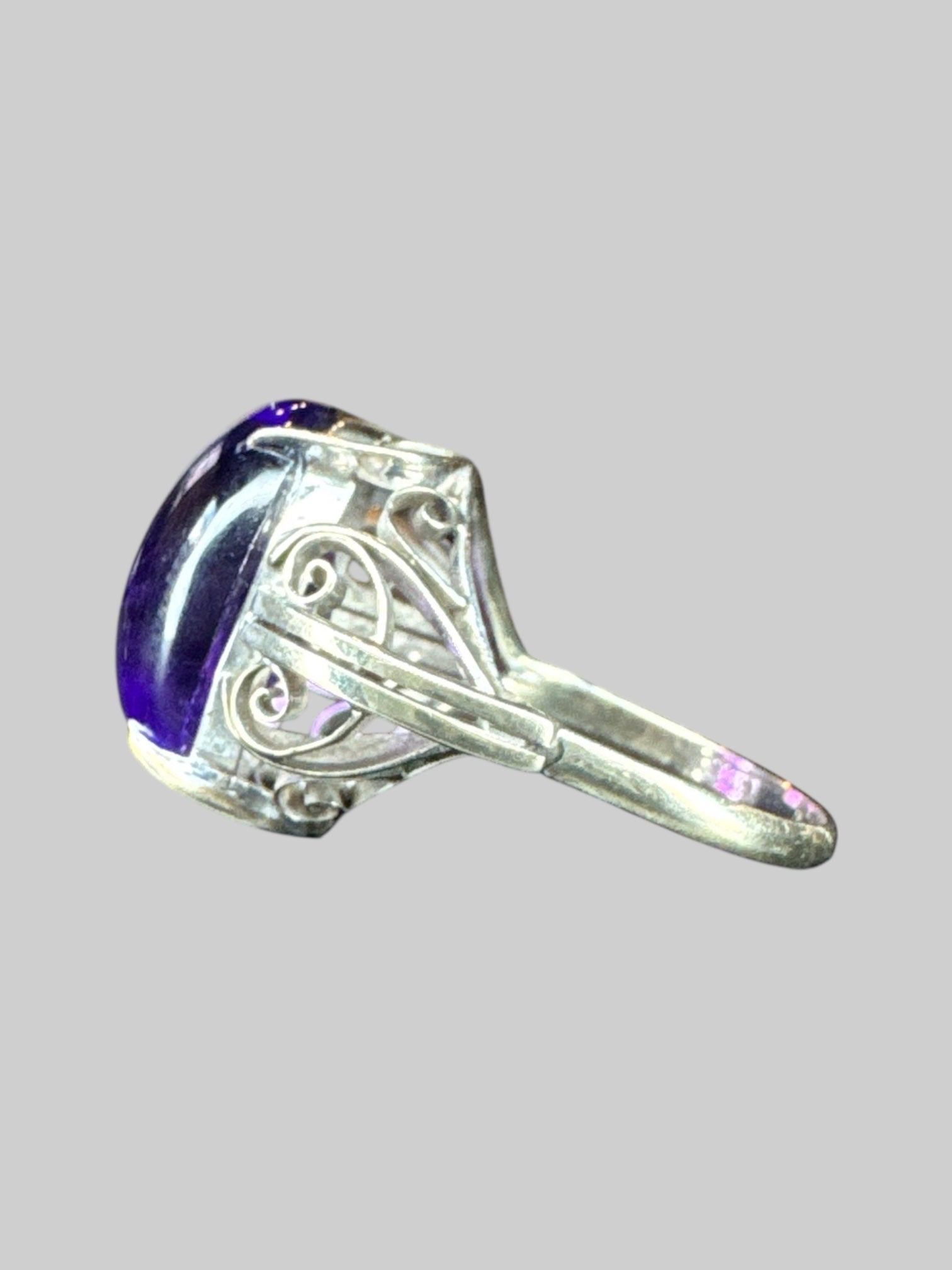 Size 9 silver colored ring with purple stone