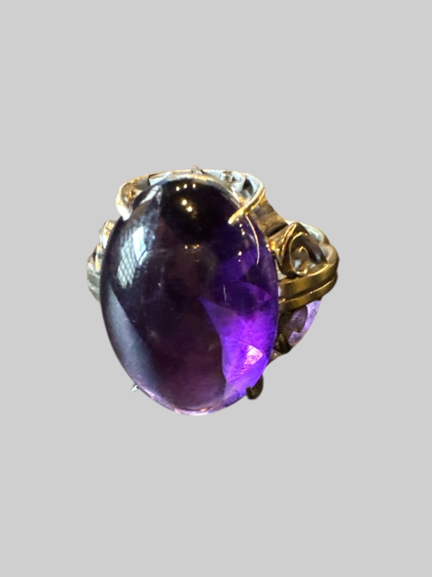 Size 9 silver colored ring with purple stone