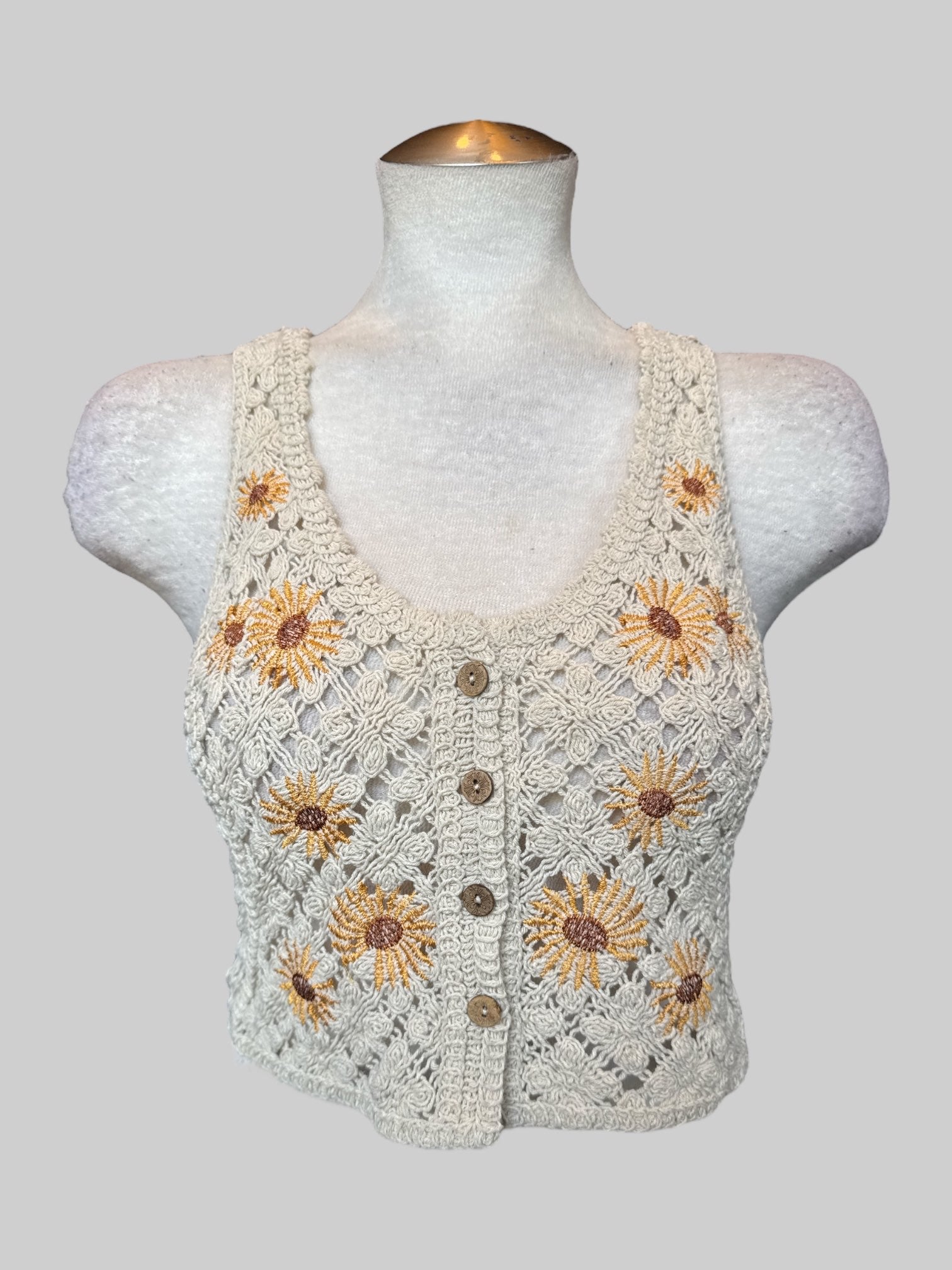 L Cream sleeveless crocheted crop top with sunflower embroidery, and buttons on front