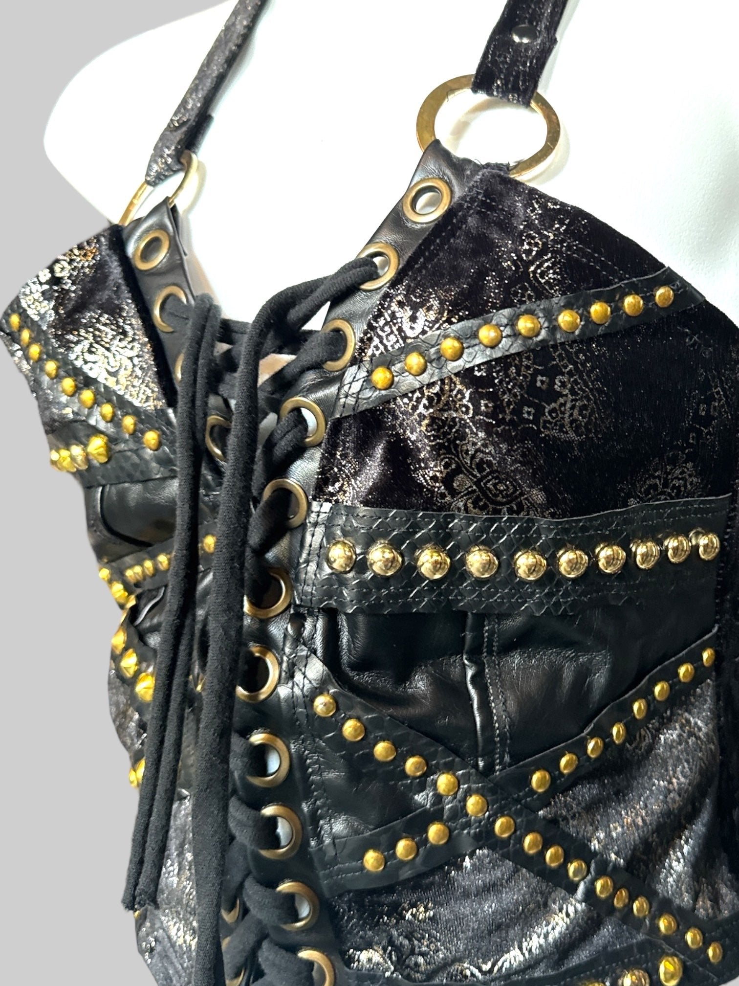 S Black lace up sleeveless top with gold color studs, black velvet with shimmery design and O ring straps that cross in the back
