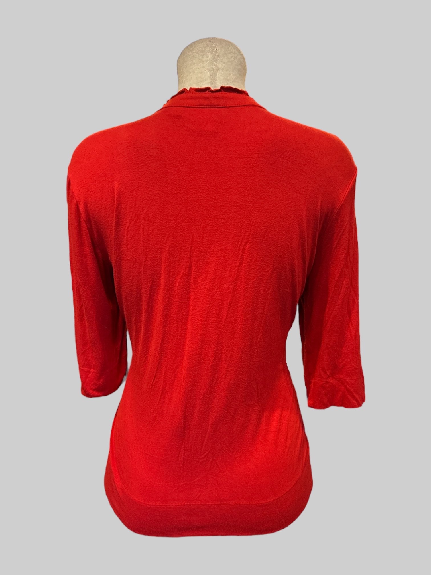 XL Red top with four buttons on front and ruffle neckline