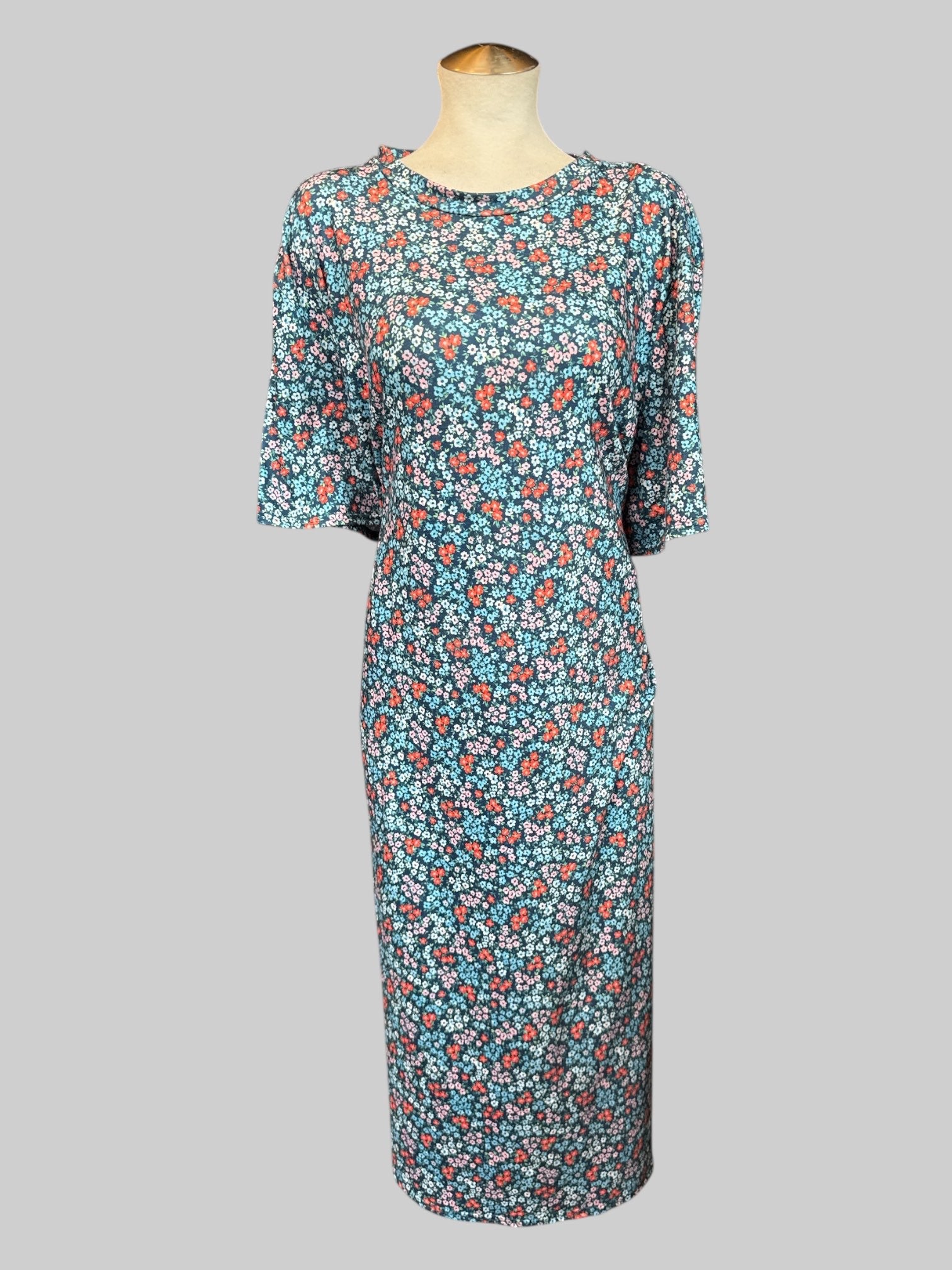 5X blue flowy maxi dress with red, pink, and blue florals and leg slit