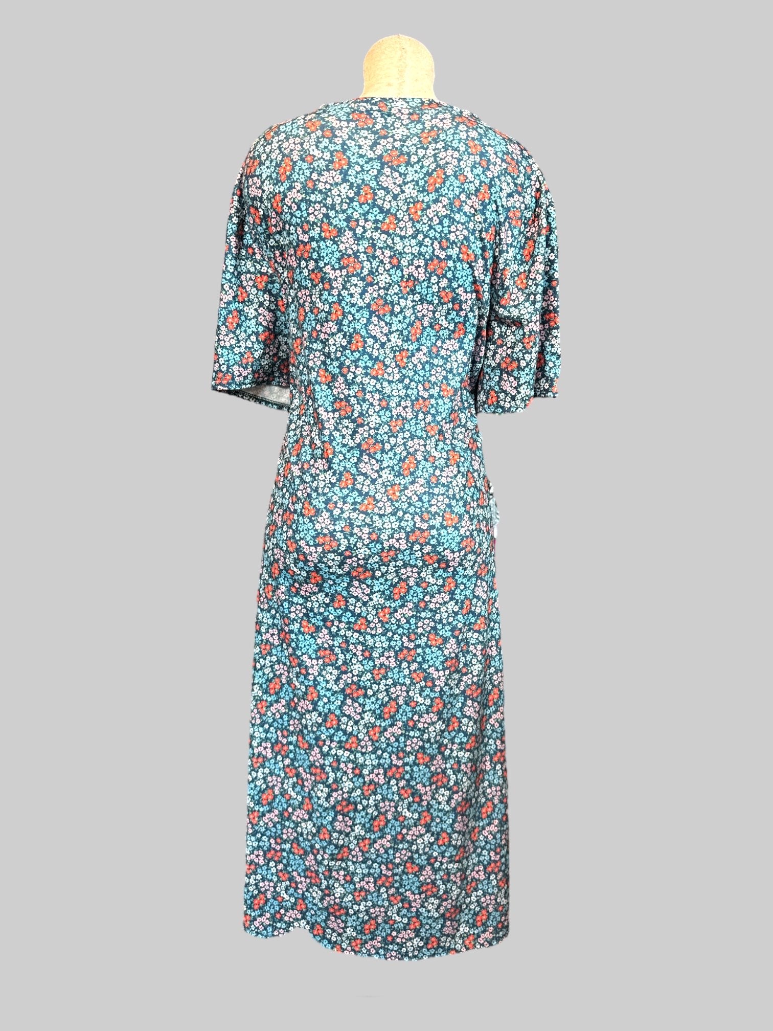 5X blue flowy maxi dress with red, pink, and blue florals and leg slit