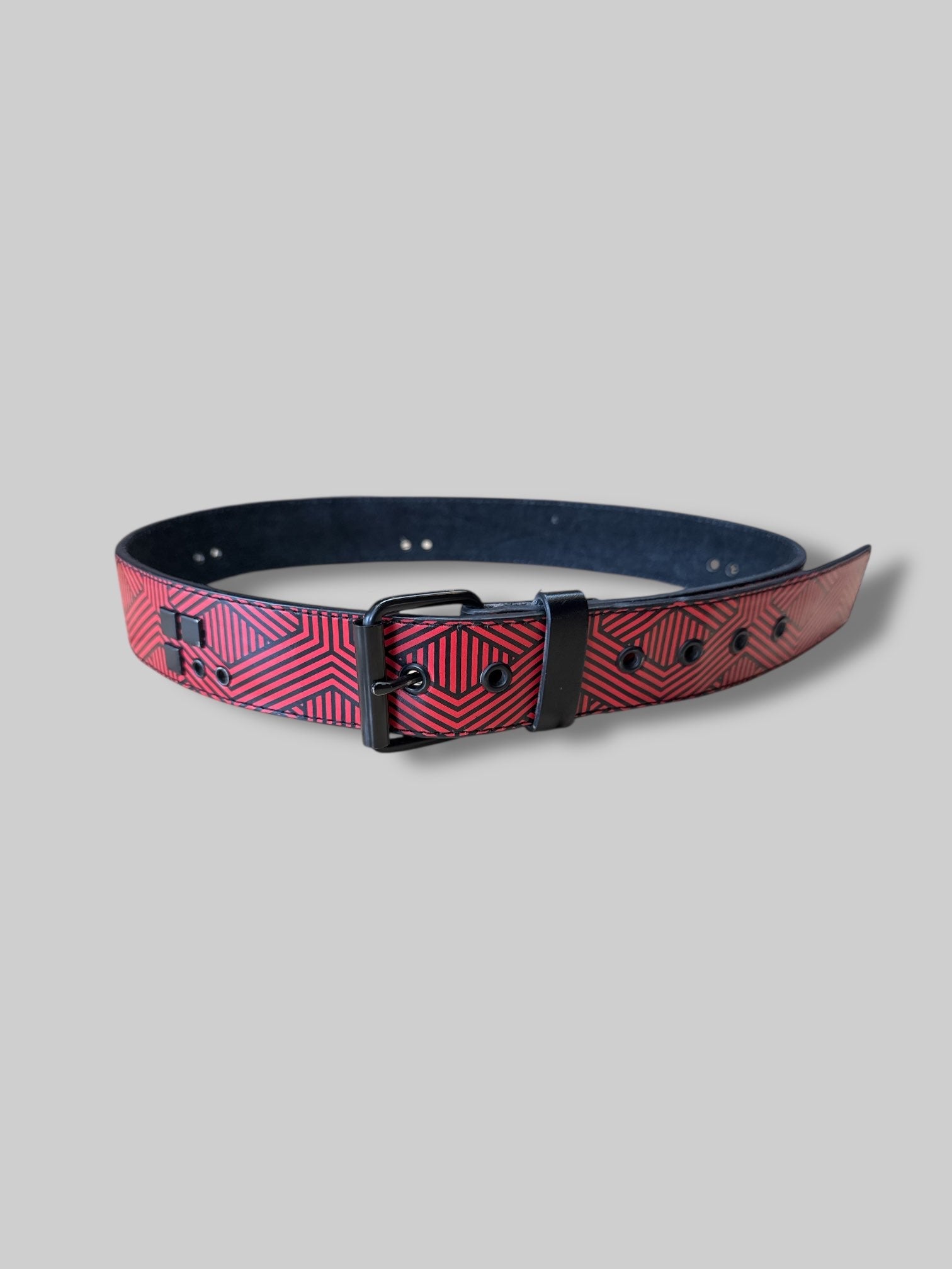 L red and black geometric belt with black studs