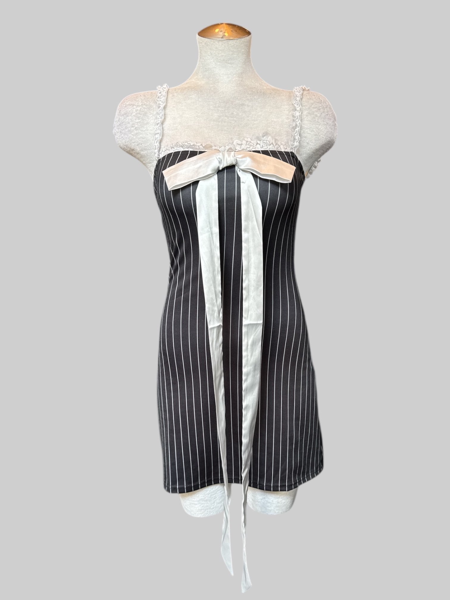 S Black and white pinstriped body con dress with lace and bow tie in front