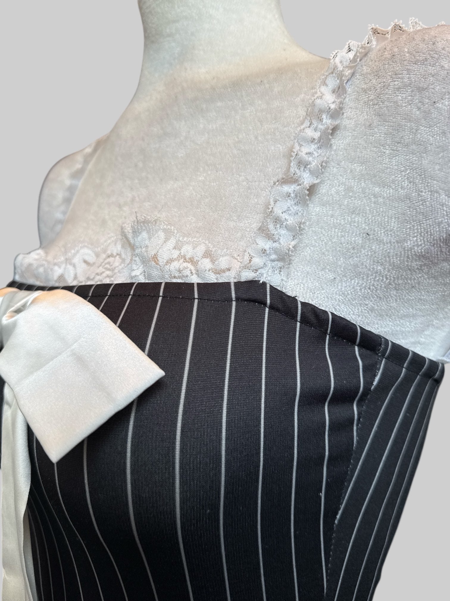 S Black and white pinstriped body con dress with lace and bow tie in front