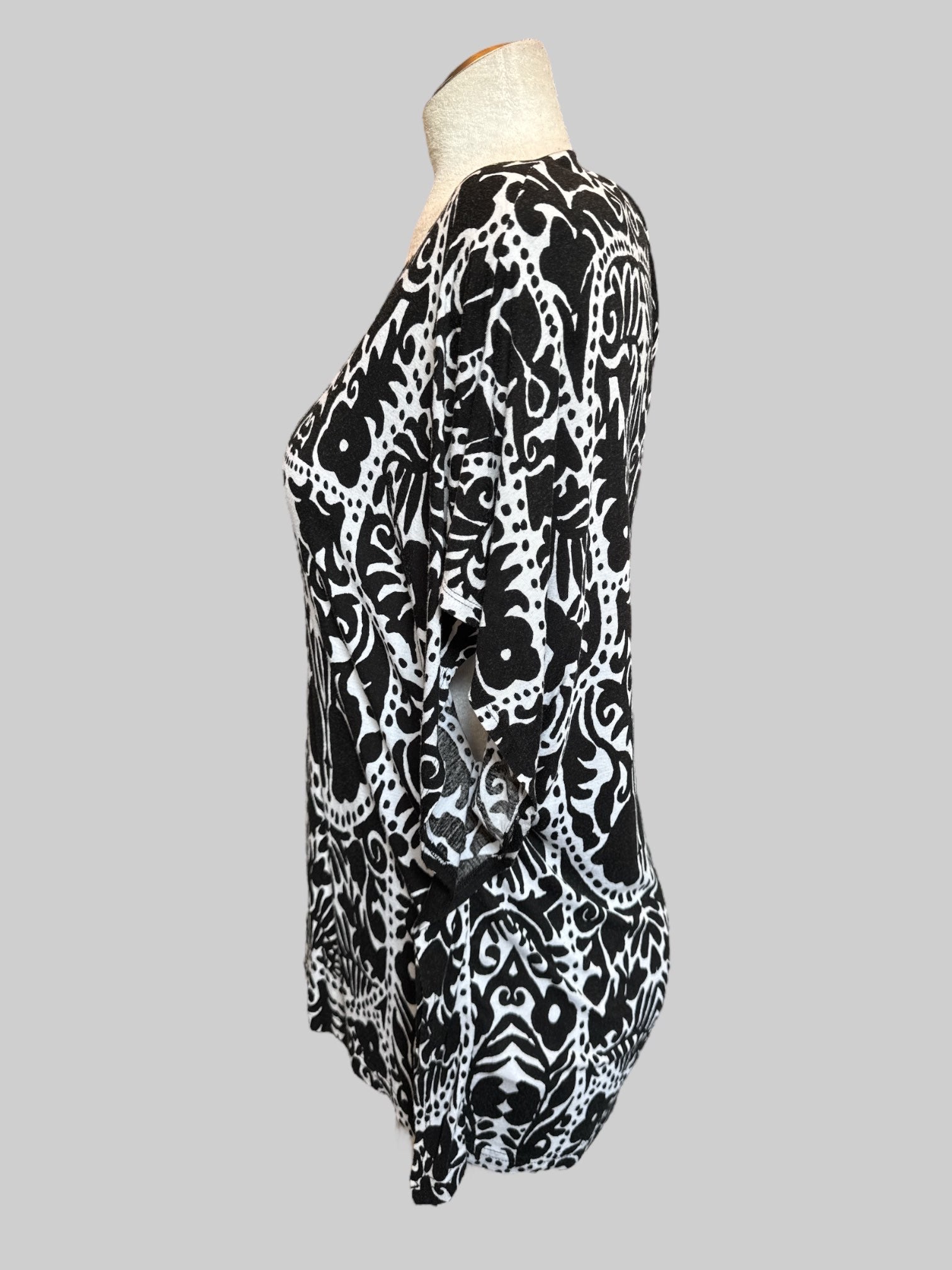 M White flowy top with black botanical prints and poncho style short sleeves