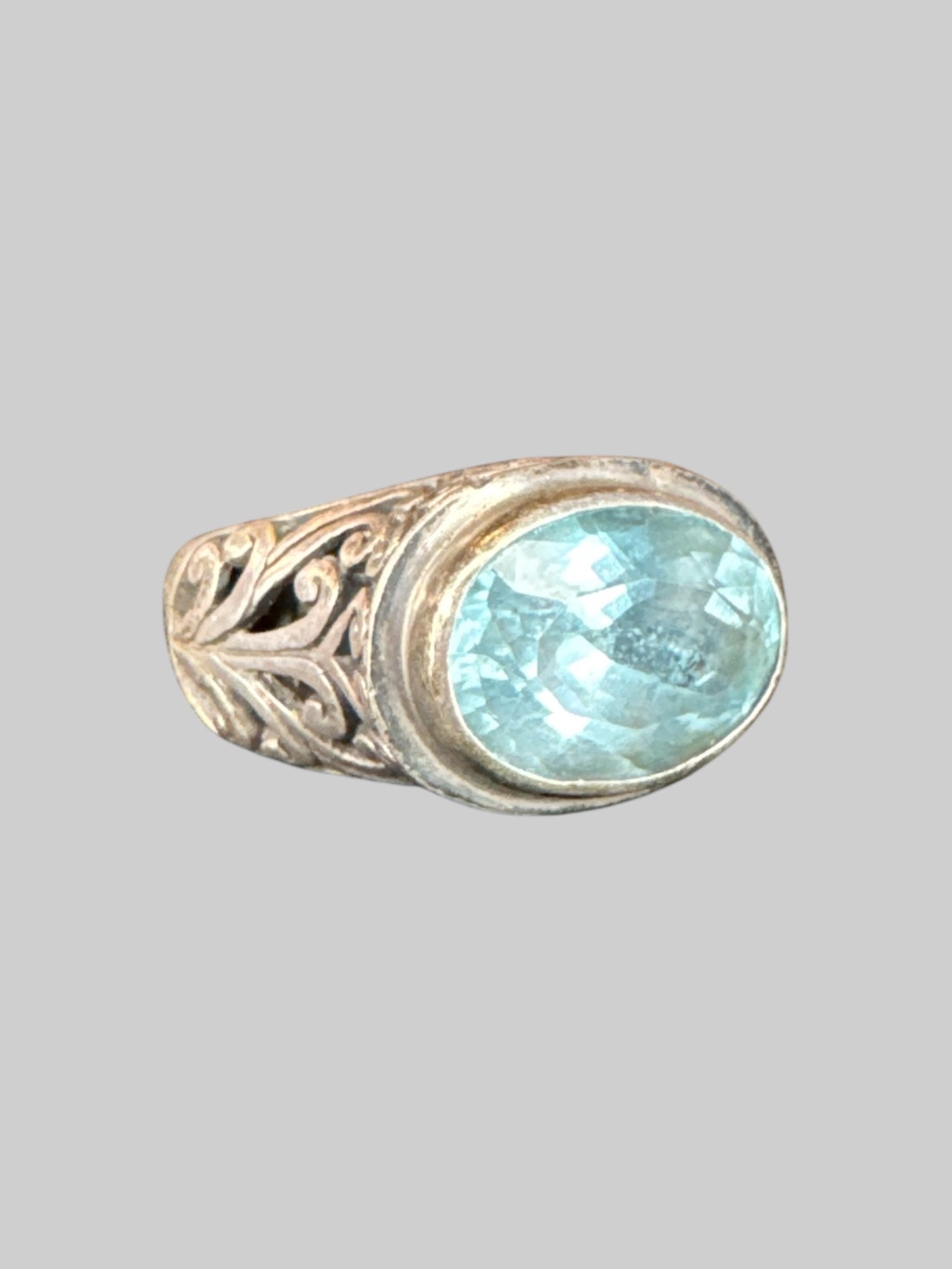 * Sterling silver ornate ring with light blue gem
