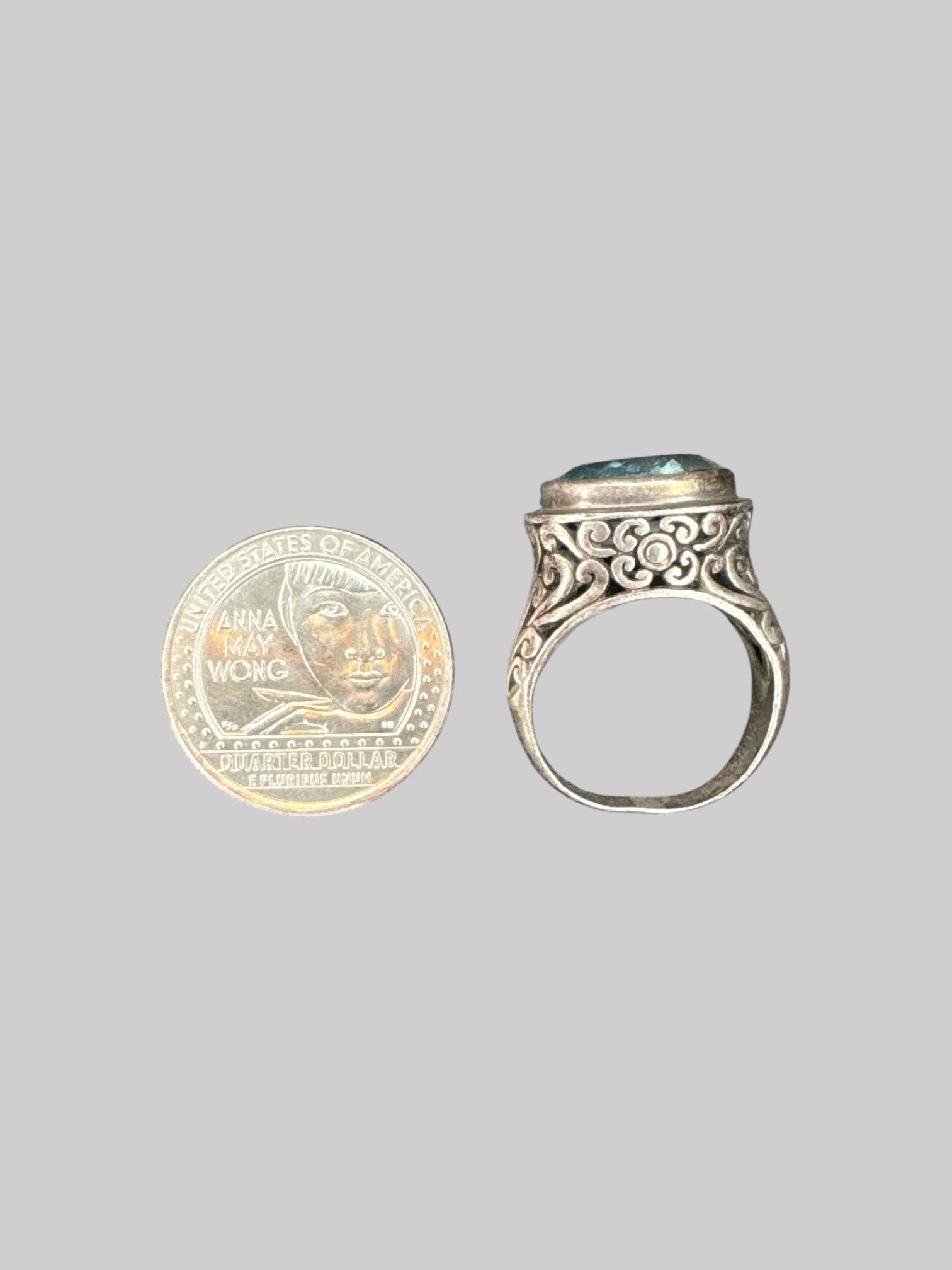 * Sterling silver ornate ring with light blue gem