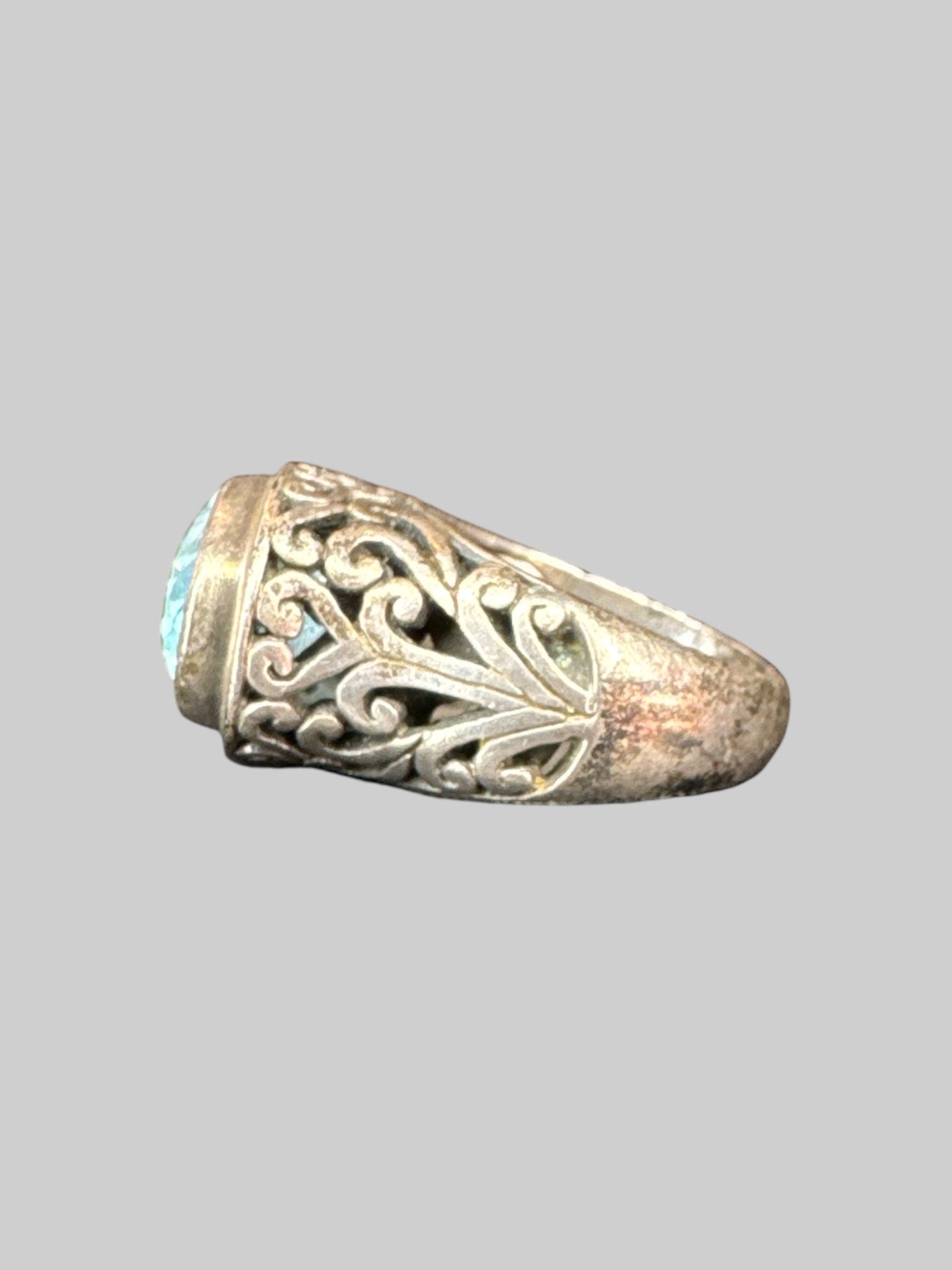 * Sterling silver ornate ring with light blue gem