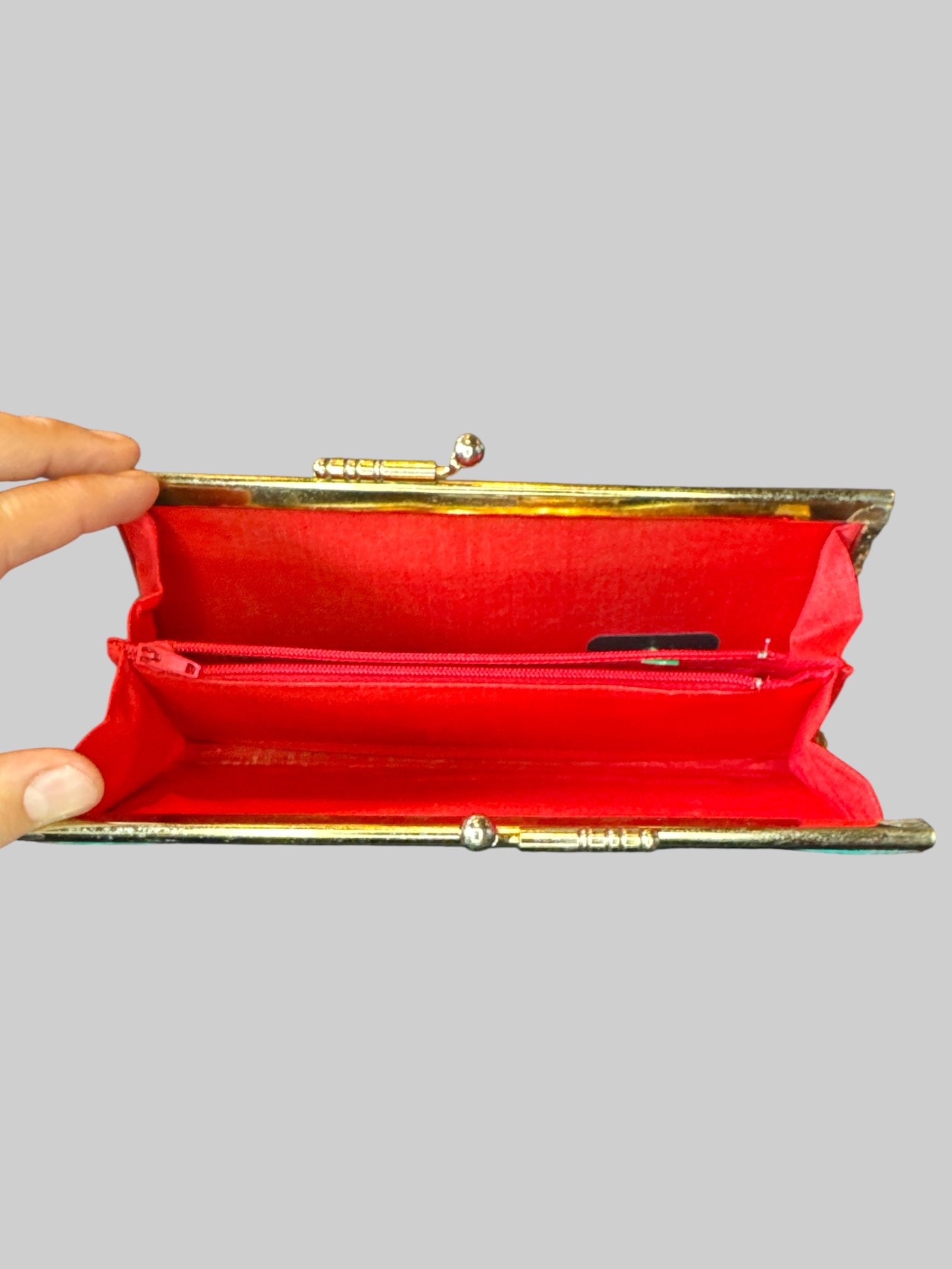 Turquoise clutch with ornate tinsel embroidery, and red inside