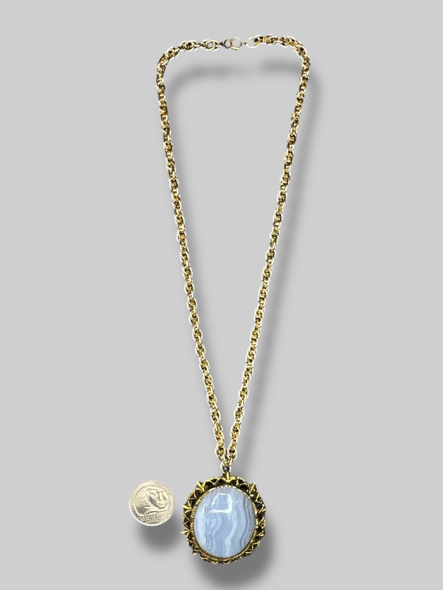 Gold chain necklace with beautiful blue stone broach as pendant