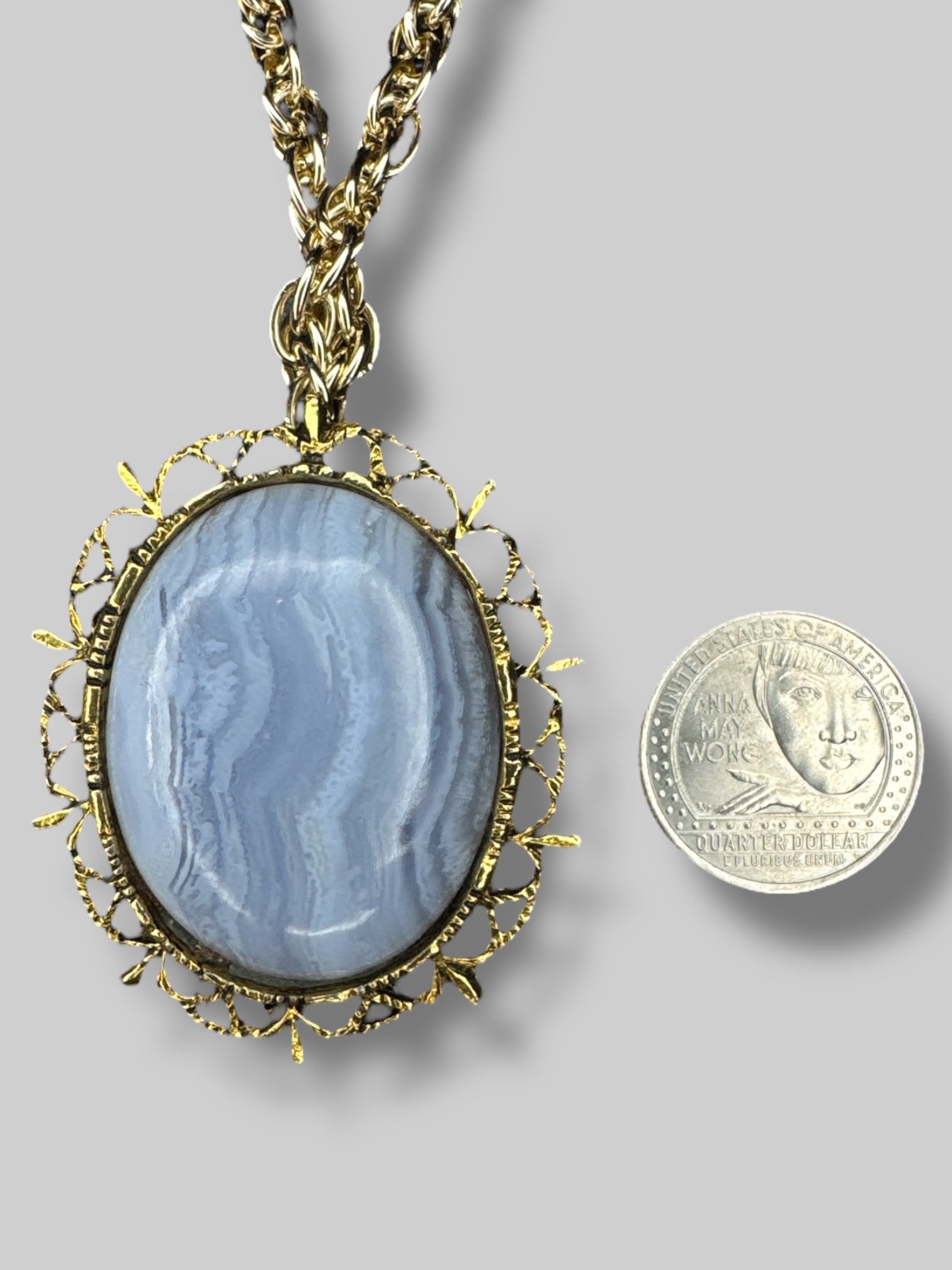 Gold chain necklace with beautiful blue stone broach as pendant