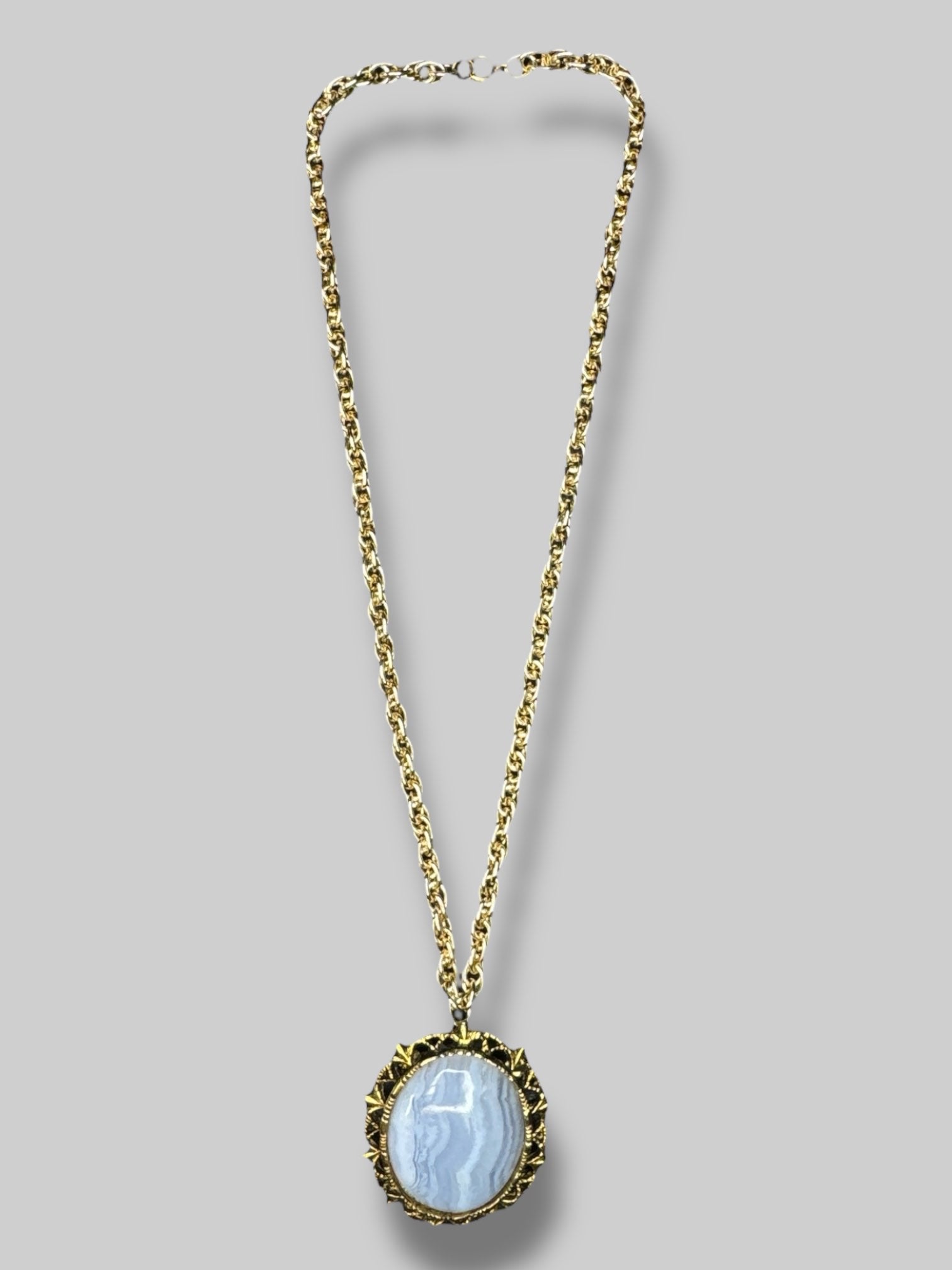 Gold chain necklace with beautiful blue stone broach as pendant