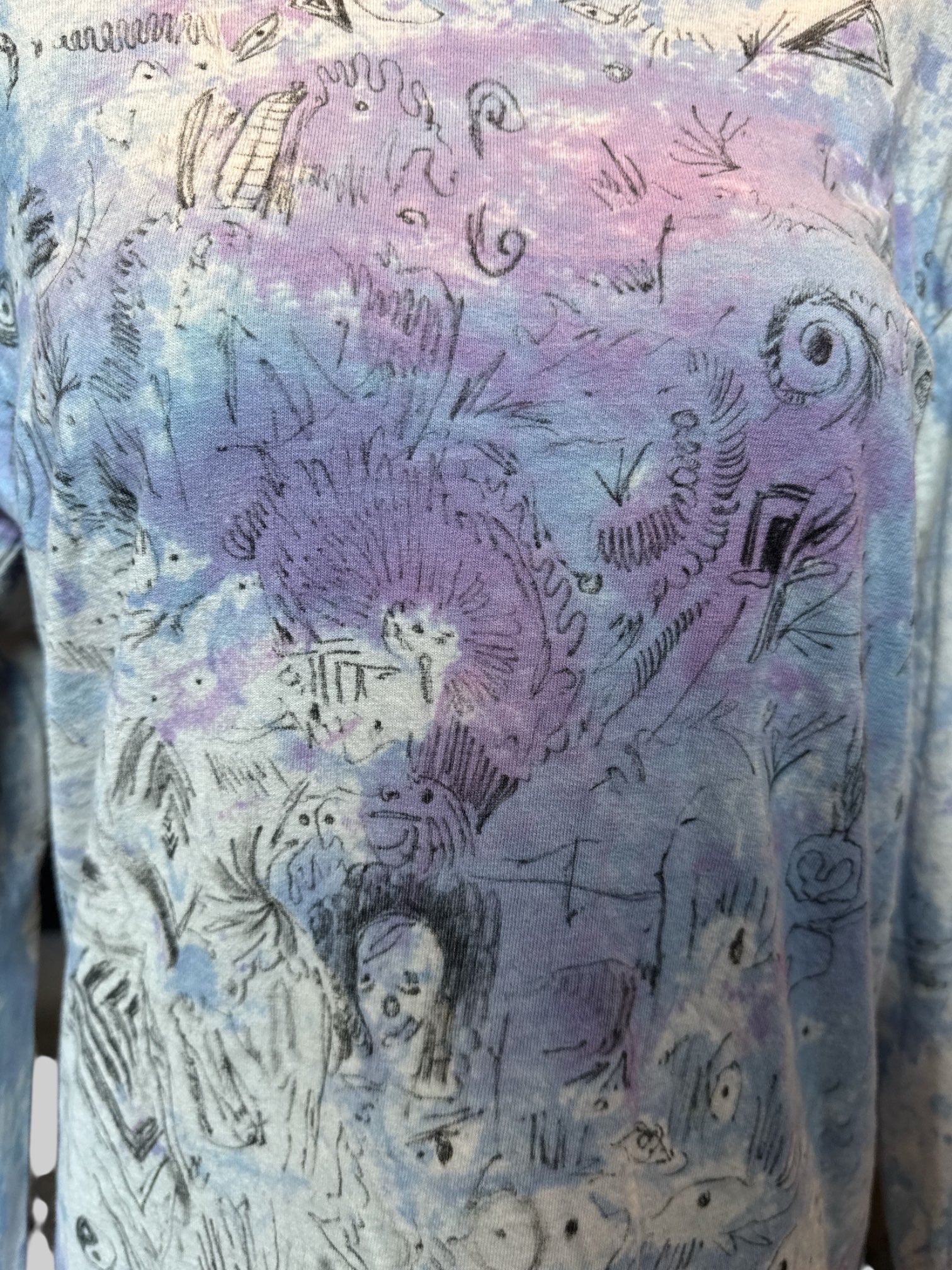 M Long sleeve blue, purple, and white tie dye shirt with art by Kevin Emerson
