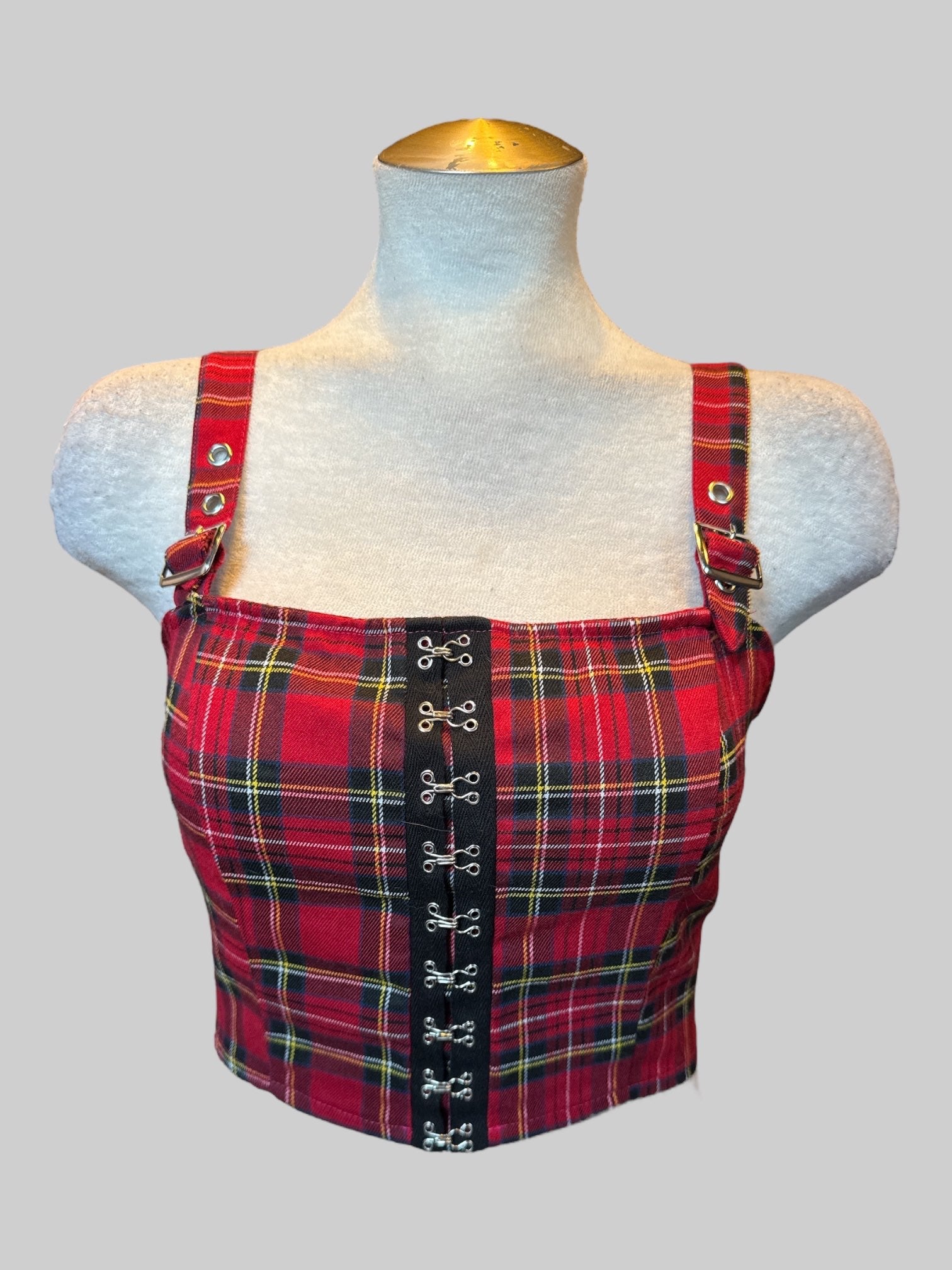 L red, black, white, yellow, and blue plaid crop top with corset style front, buckle straps, and shirred back