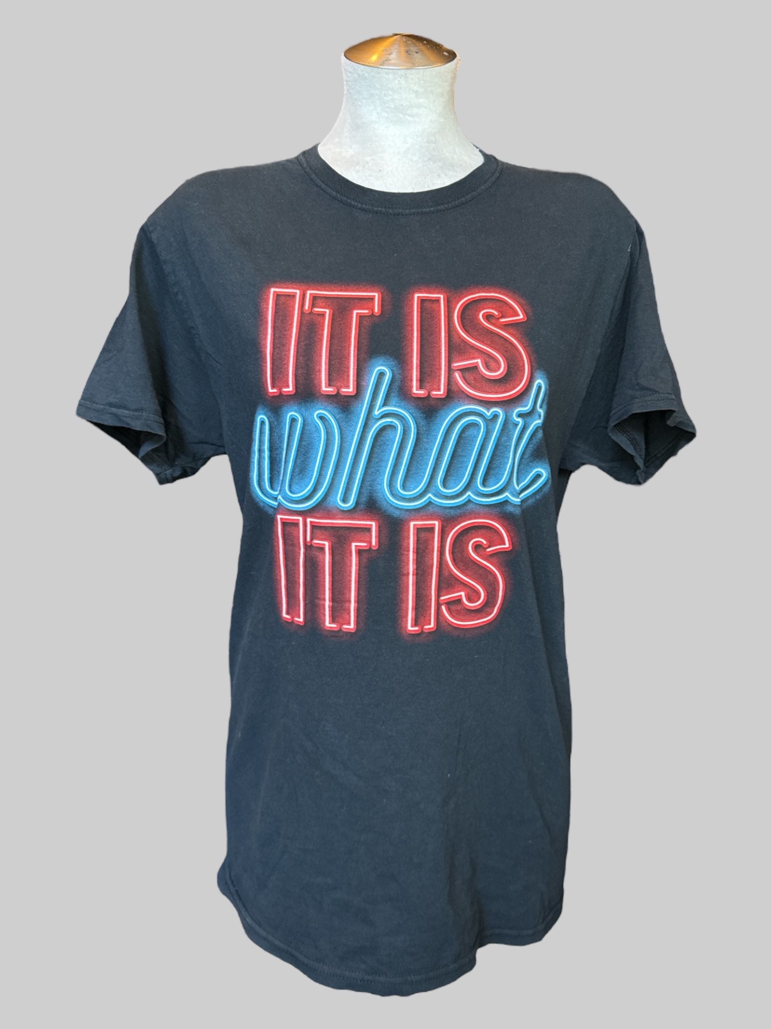 M Black tee with “It is what it is” graphic