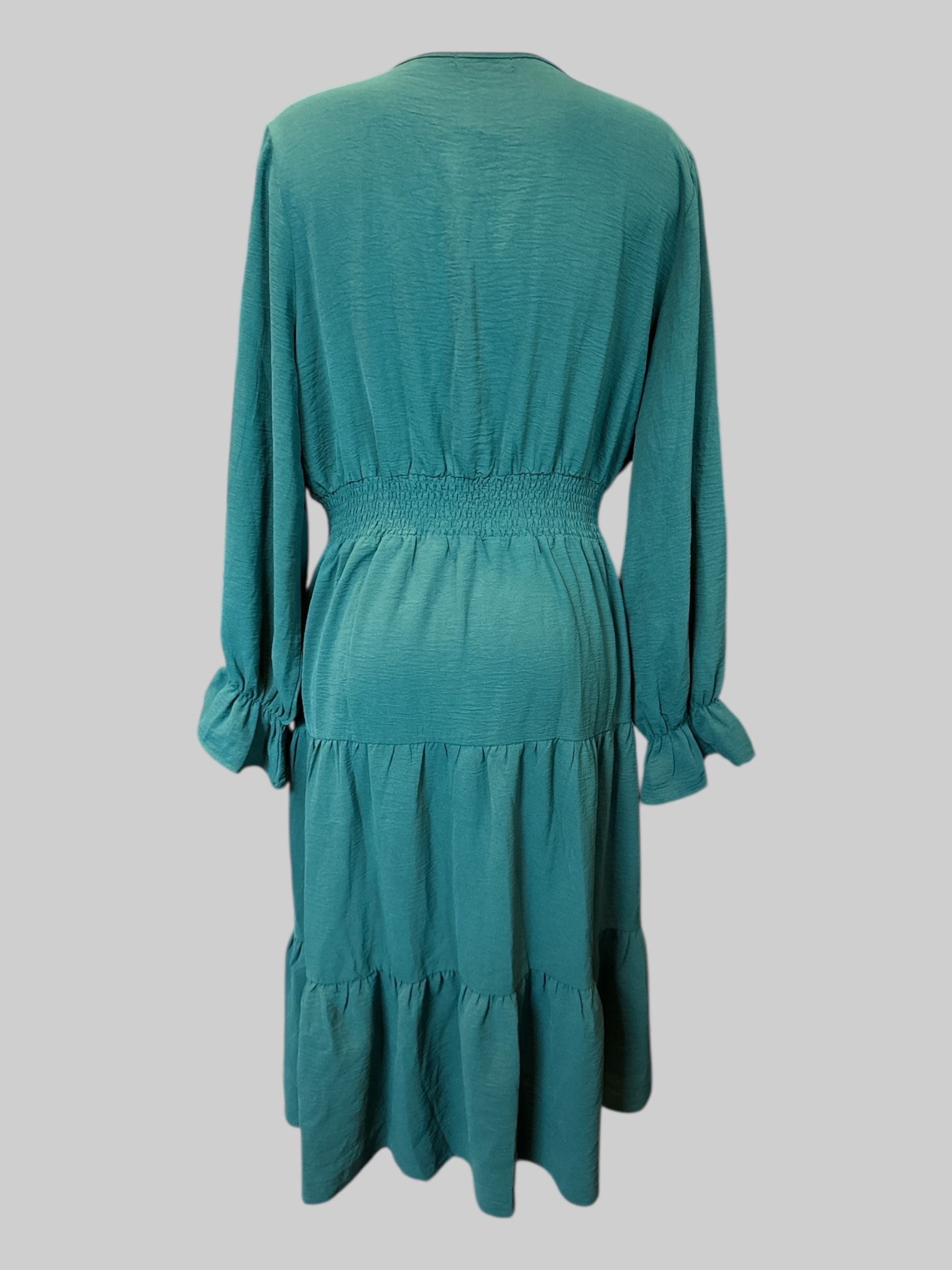 2X Dark green long sleeve dress with faux wrap top, shirred waist, tiered design on bottom, and balloon sleeves