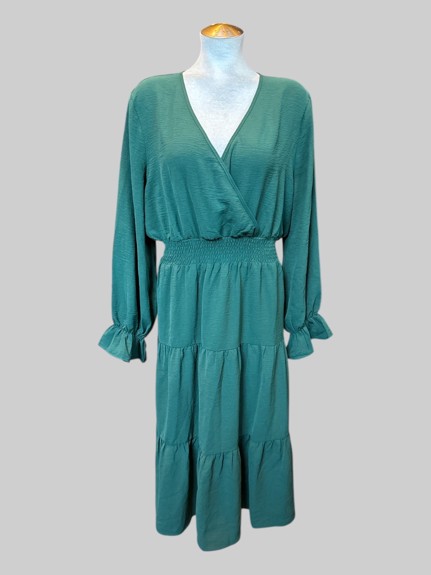 2X Dark green long sleeve dress with faux wrap top, shirred waist, tiered design on bottom, and balloon sleeves