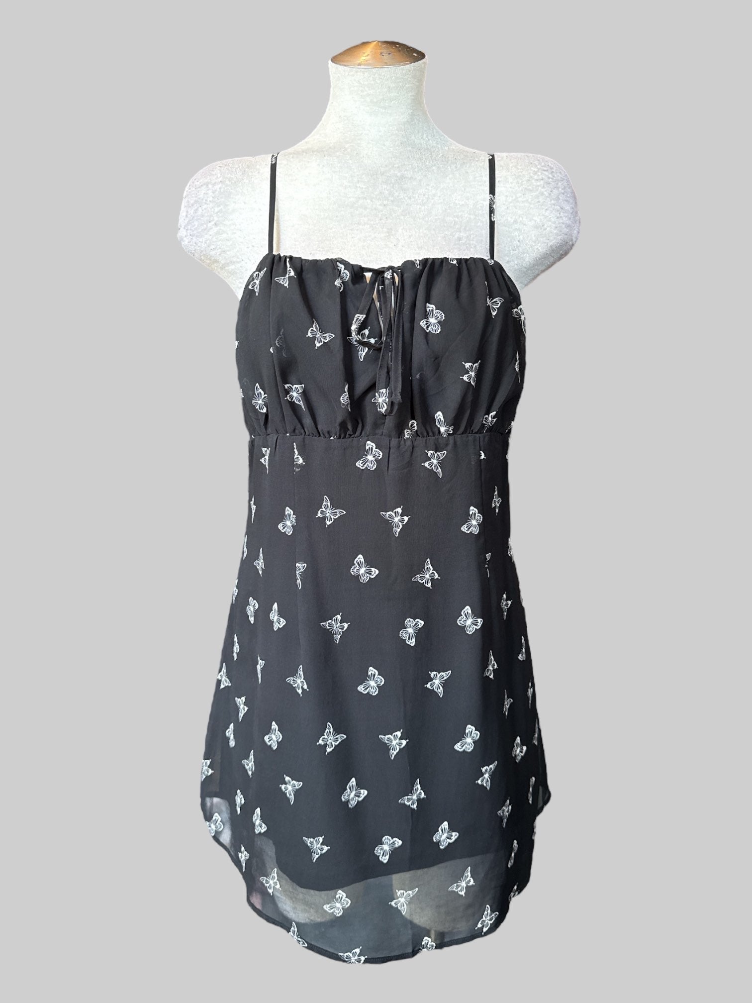 L Black sleeveless dress with butterfly print, tie on front, and zipper on side