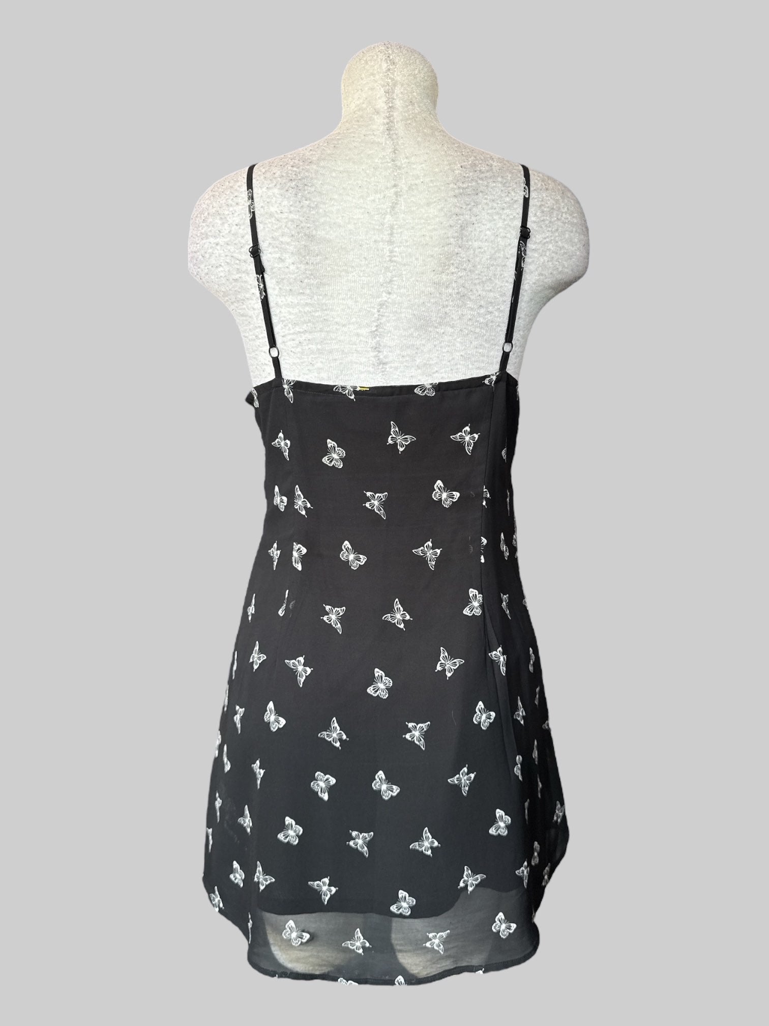 L Black sleeveless dress with butterfly print, tie on front, and zipper on side