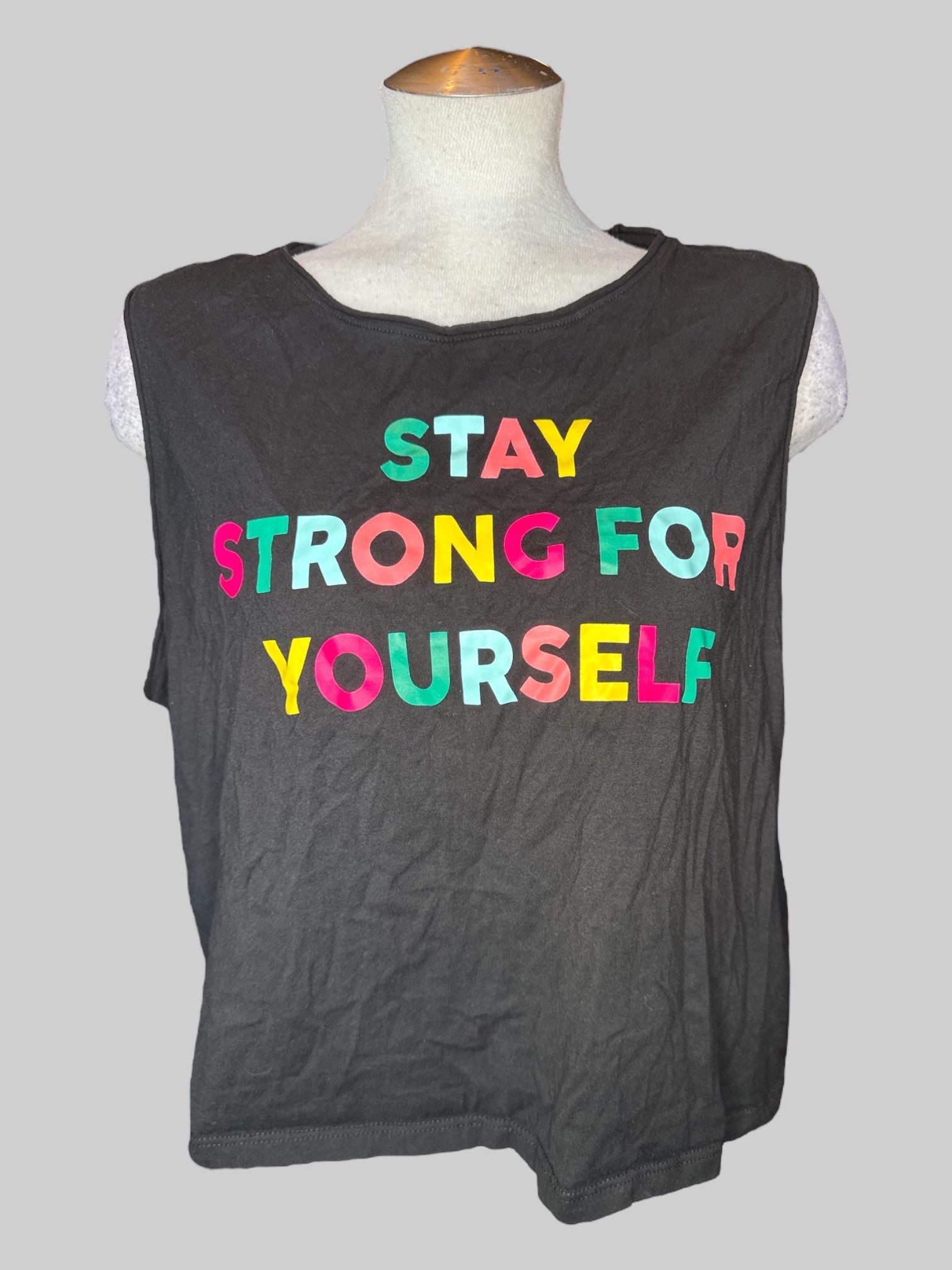 0X Black crop top with cut off sleeves, and “Stay strong for yourself” graphic