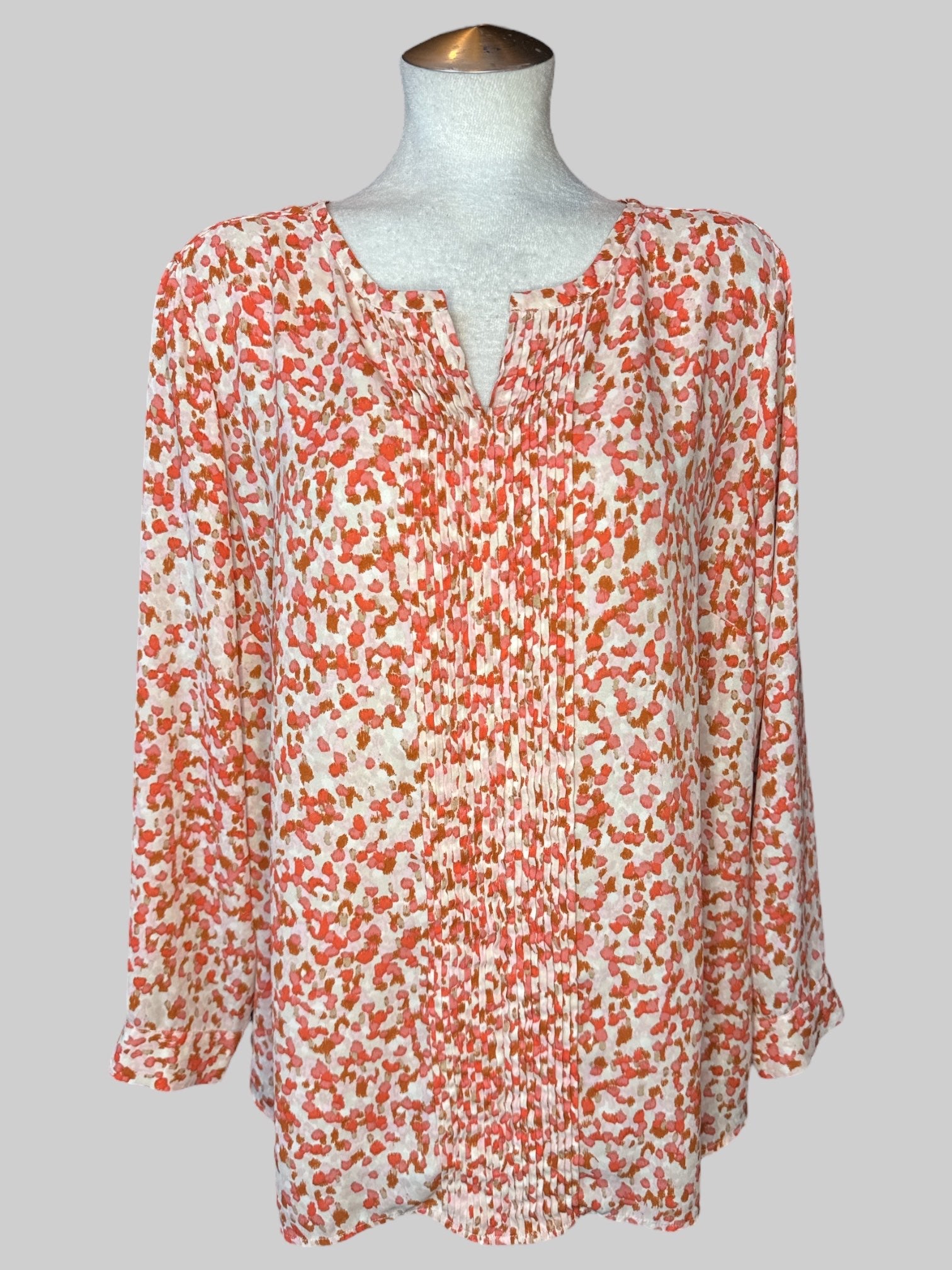 1X Off-white top with pink and brown spots, pleated design on front, and buttons on sleeves
