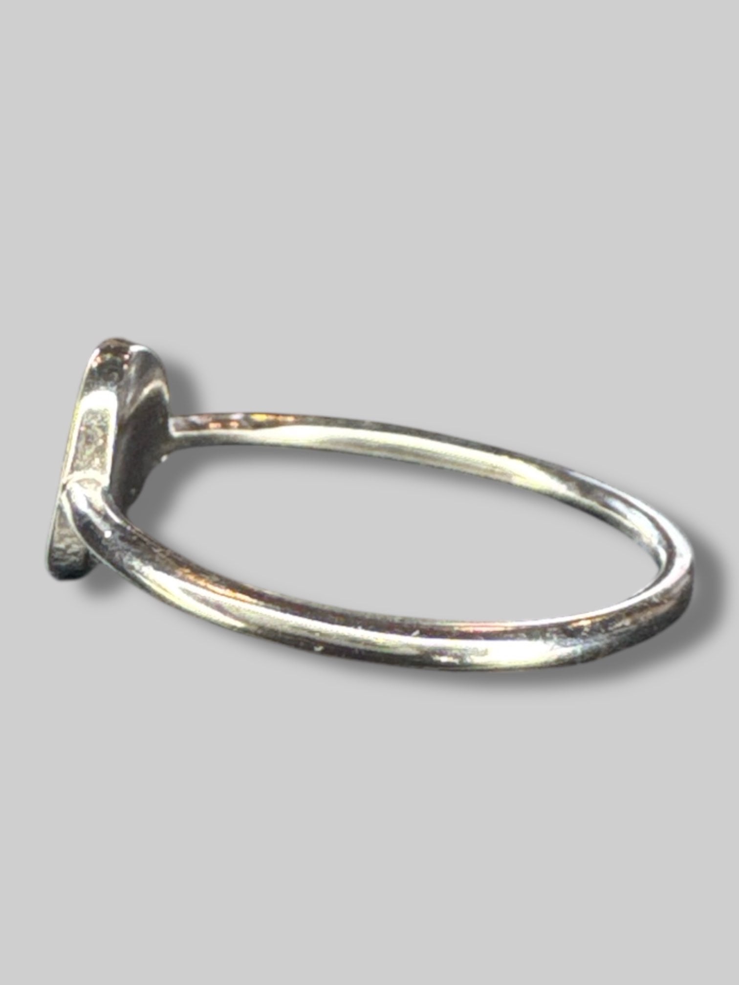 Silvertone ring with pinky cross pendant