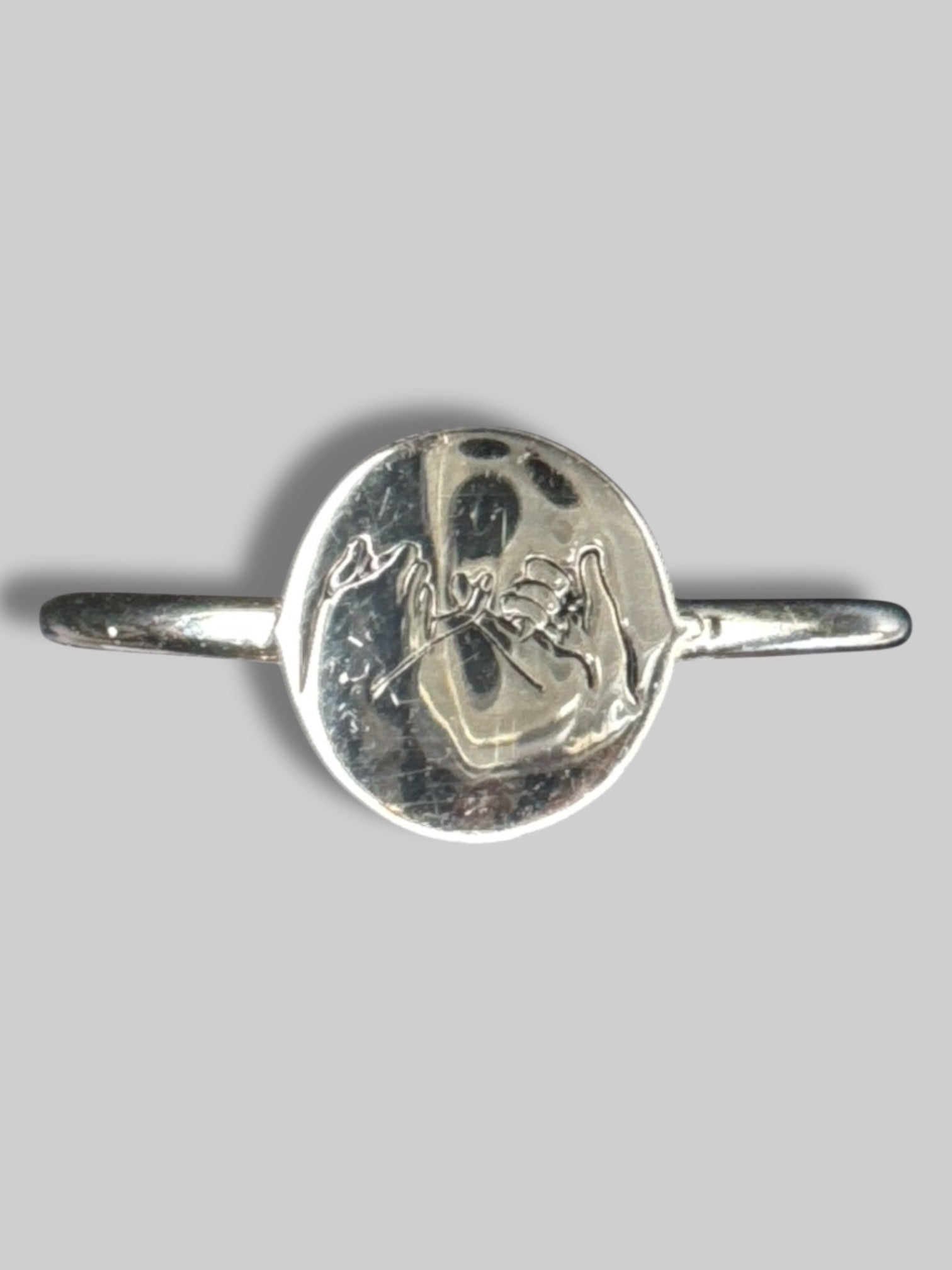Silvertone ring with pinky cross pendant