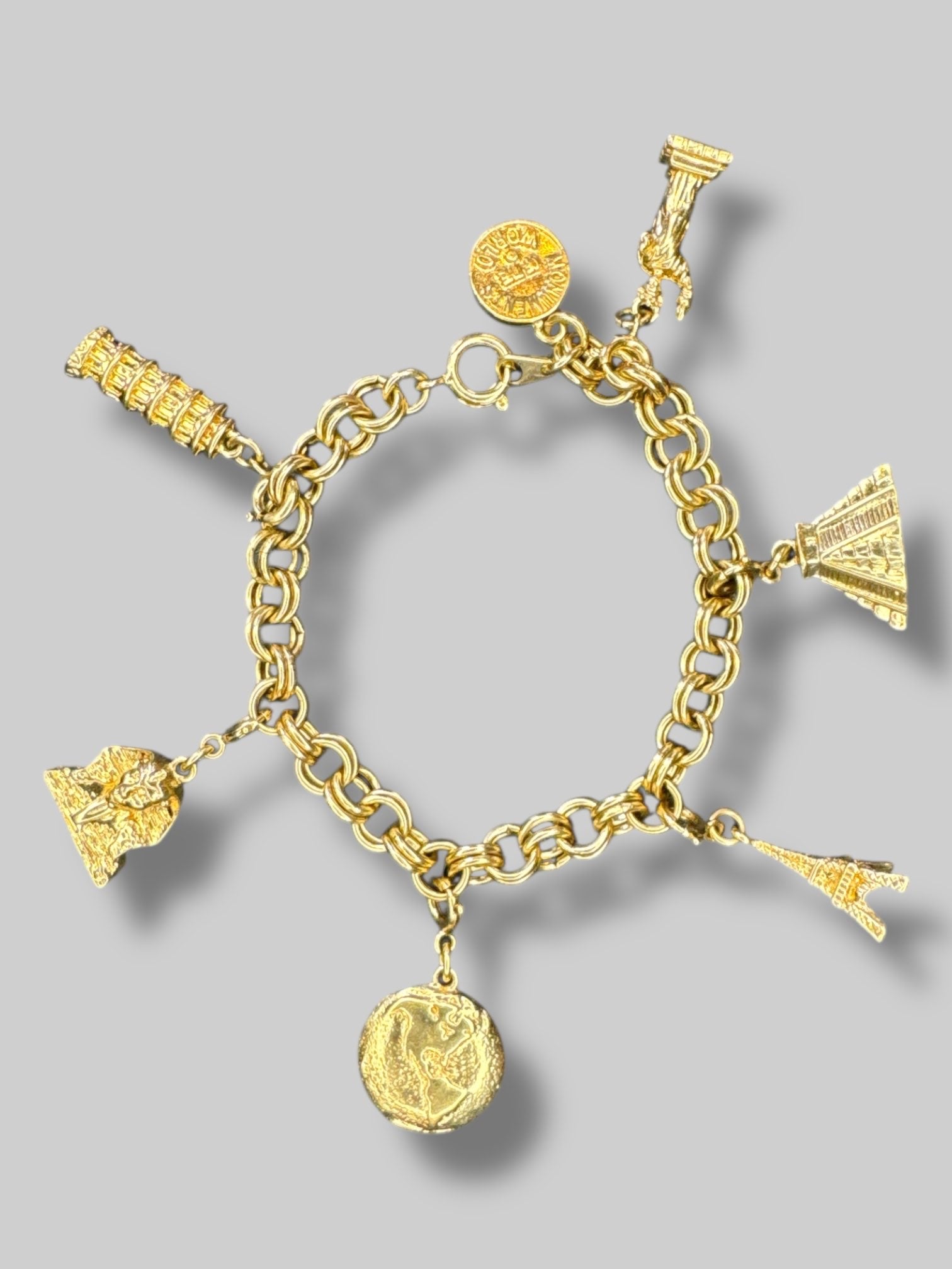 Gold tone “Monuments of the world” charm bracelet