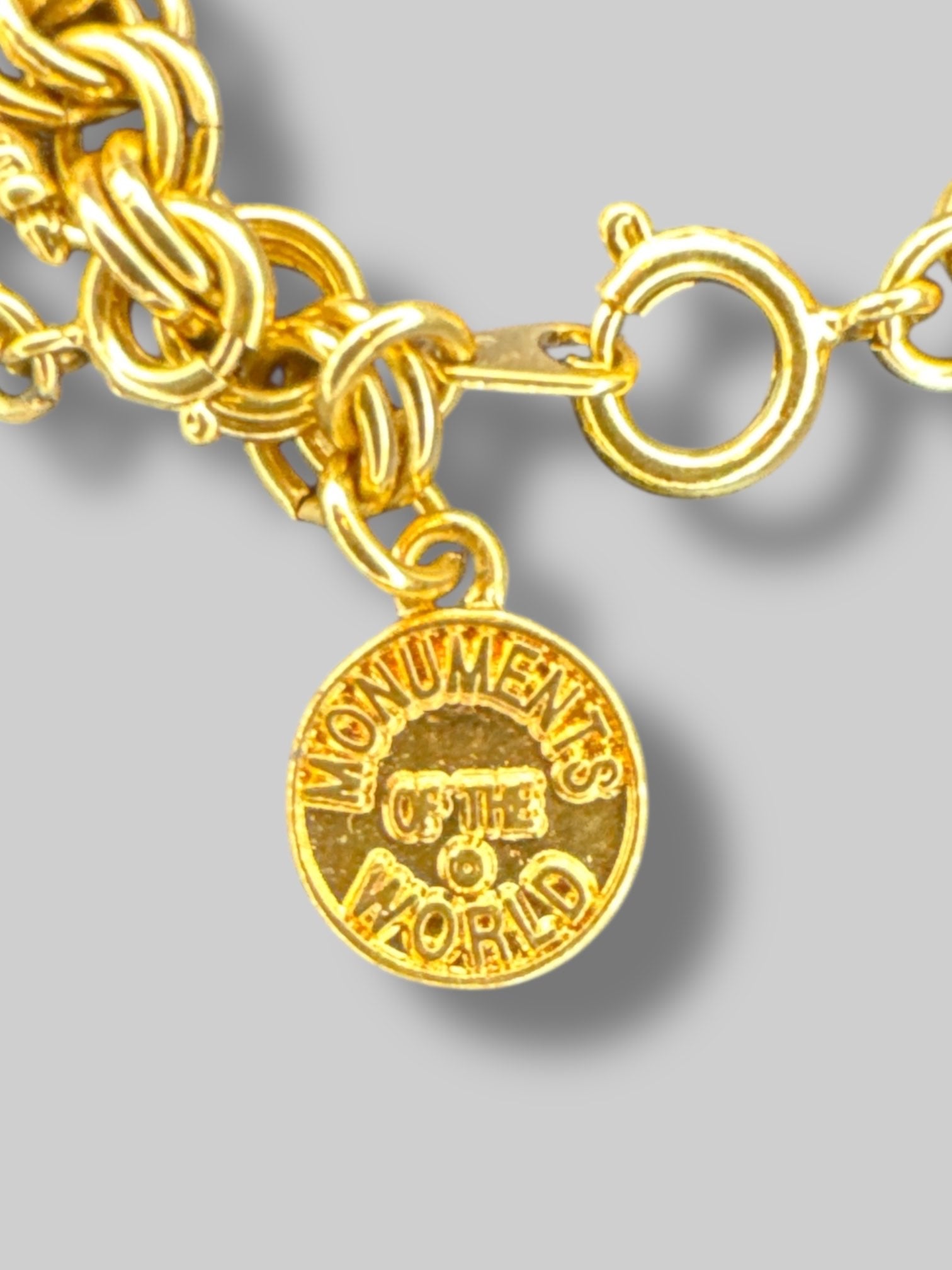 Gold tone “Monuments of the world” charm bracelet