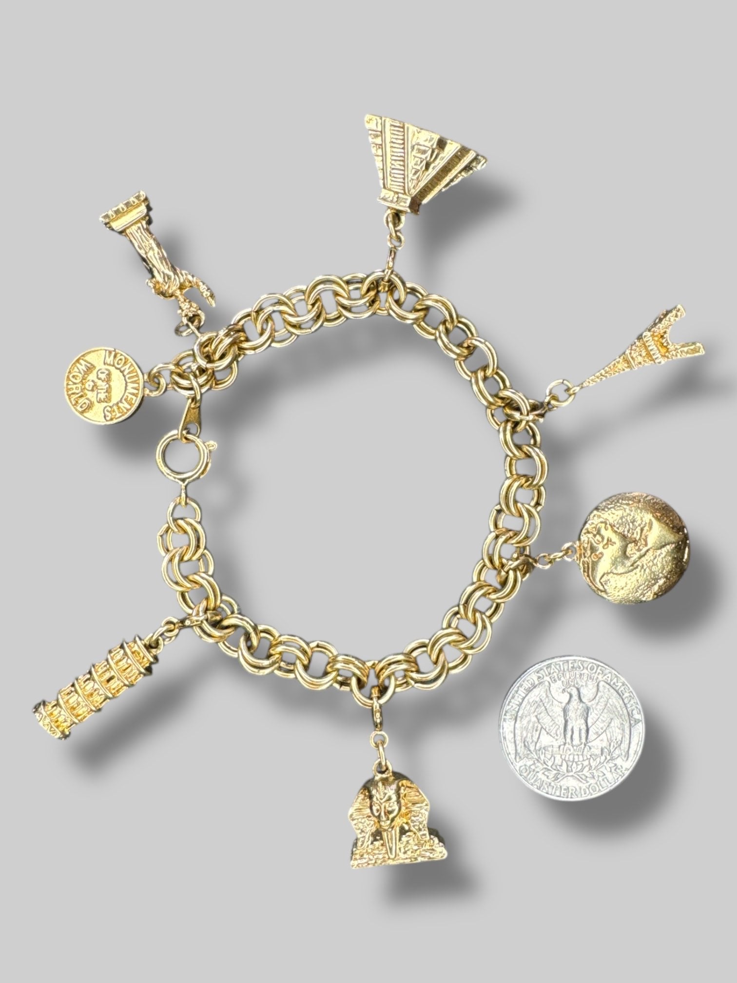 Gold tone “Monuments of the world” charm bracelet