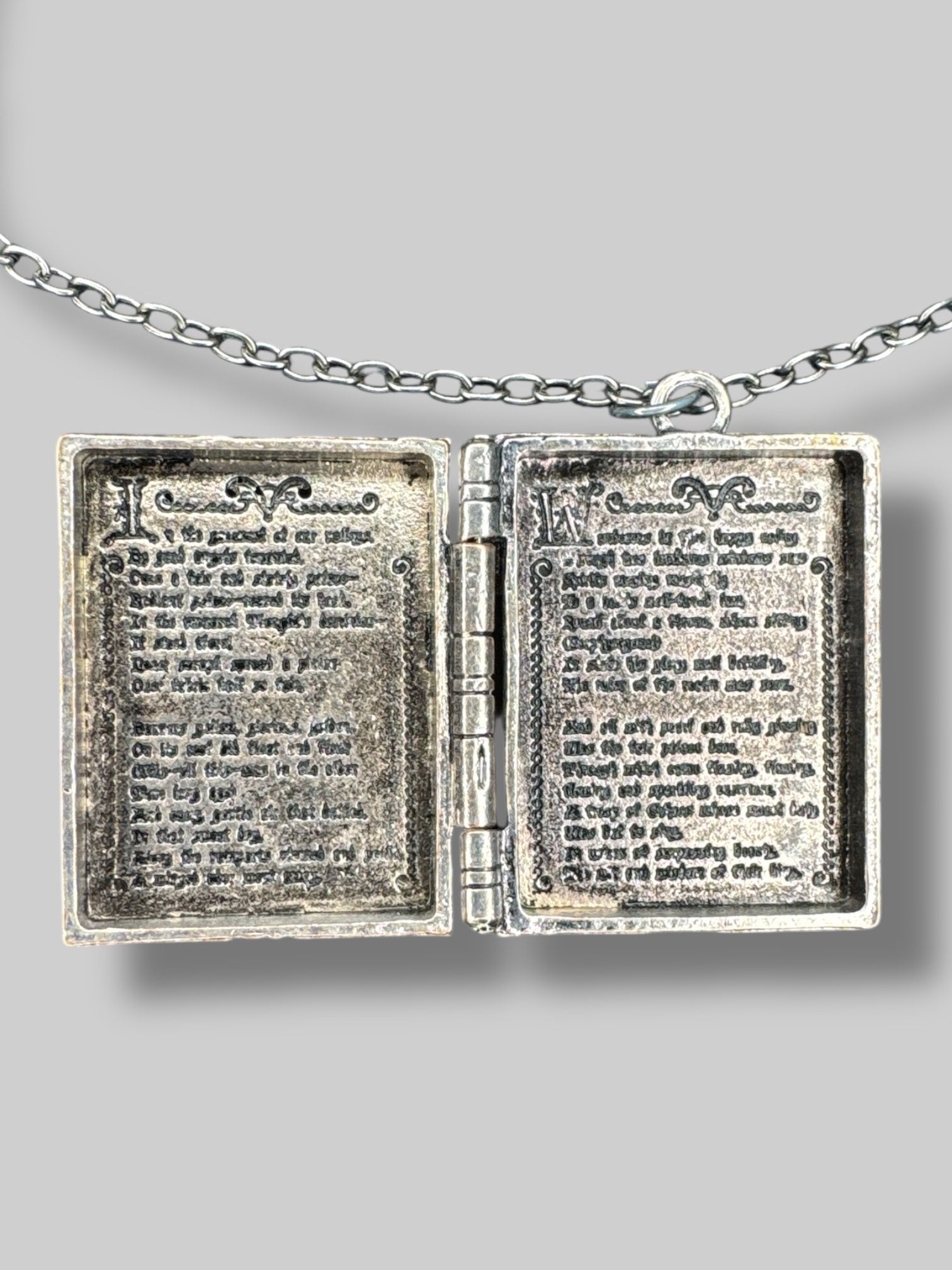 Silver tone “Dark poetry” book locket with purple and black gems on front
