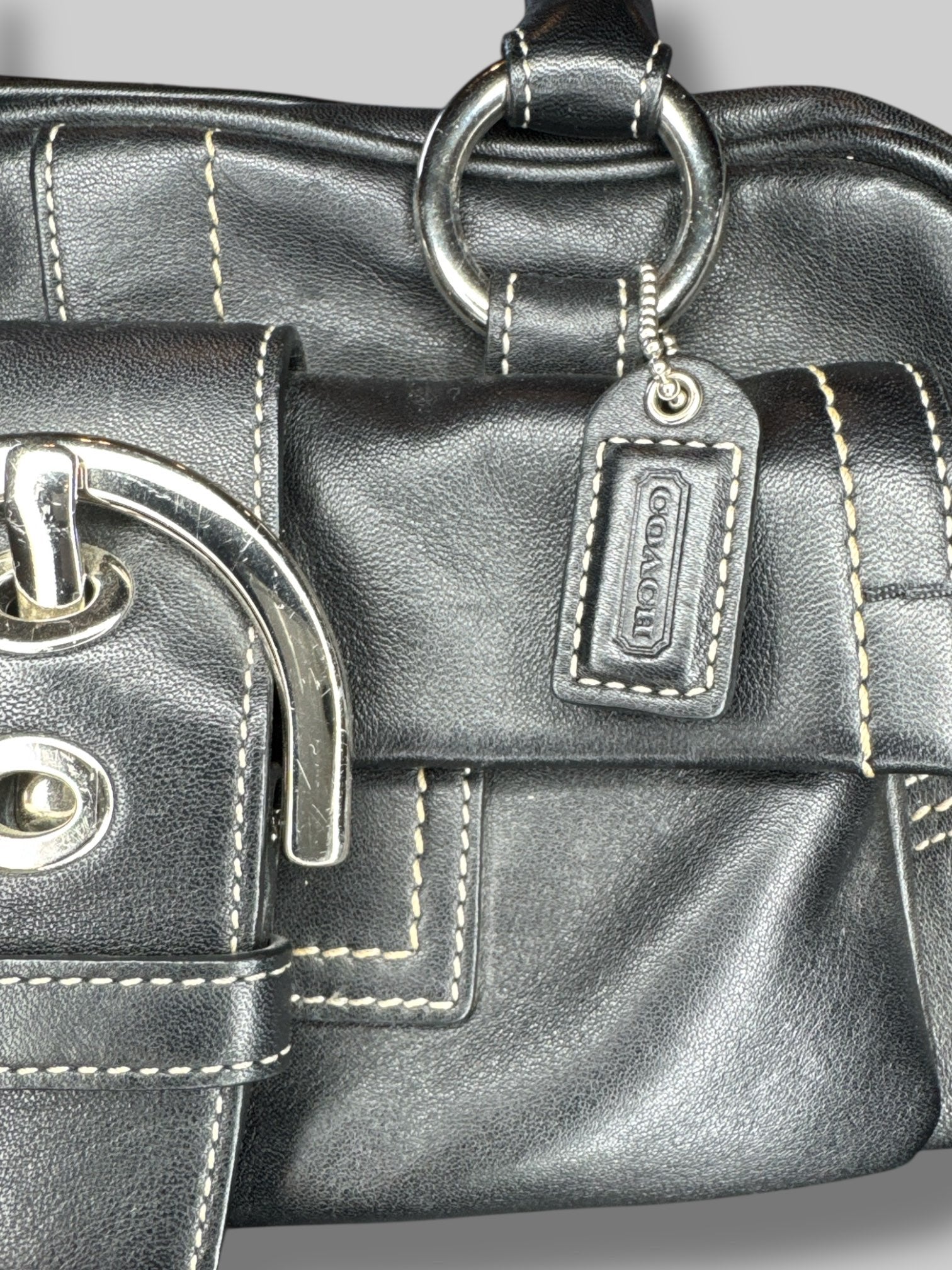 Black leather Coach hand bag with multiple pockets inside and out